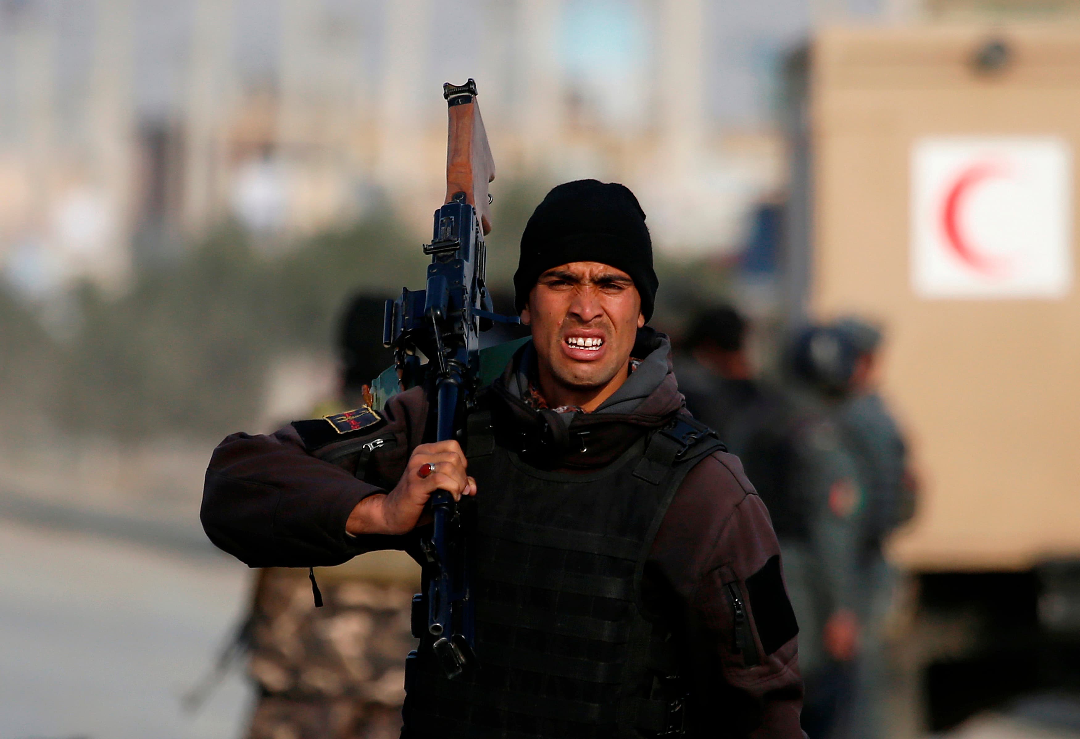 An Afghan security soldier holds his rifle on his shoulder near the Independent Election Commission headquarters, which was atttacked by Taliban insurgents, in Kabul March 29, 2014.