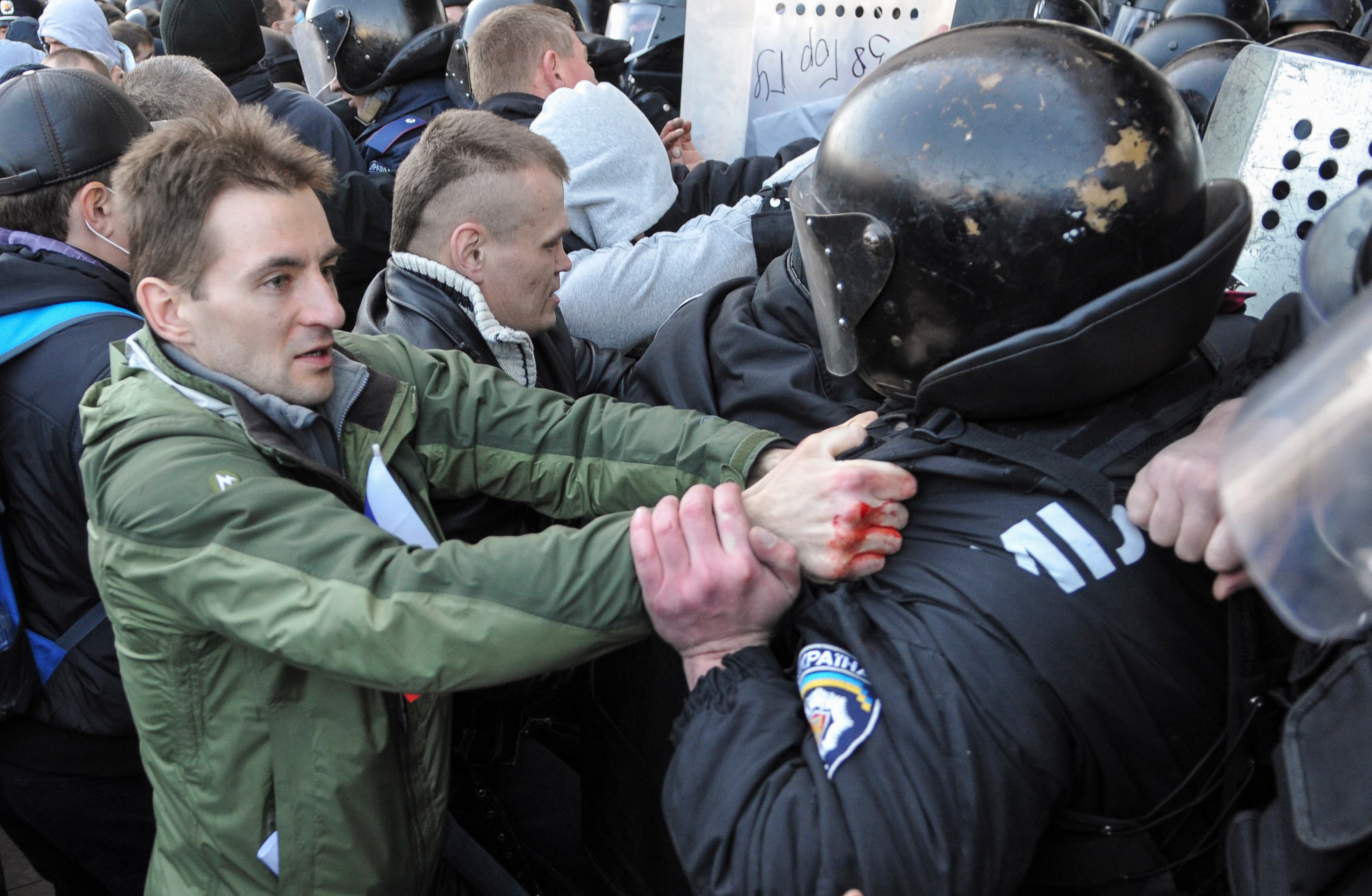 Pro-Russian activists scuffle with police near the regional government building in the eastern Ukrainian city of Donetsk. Protesters hung up a Russian flag in defiance of Kiev's pro-European government.