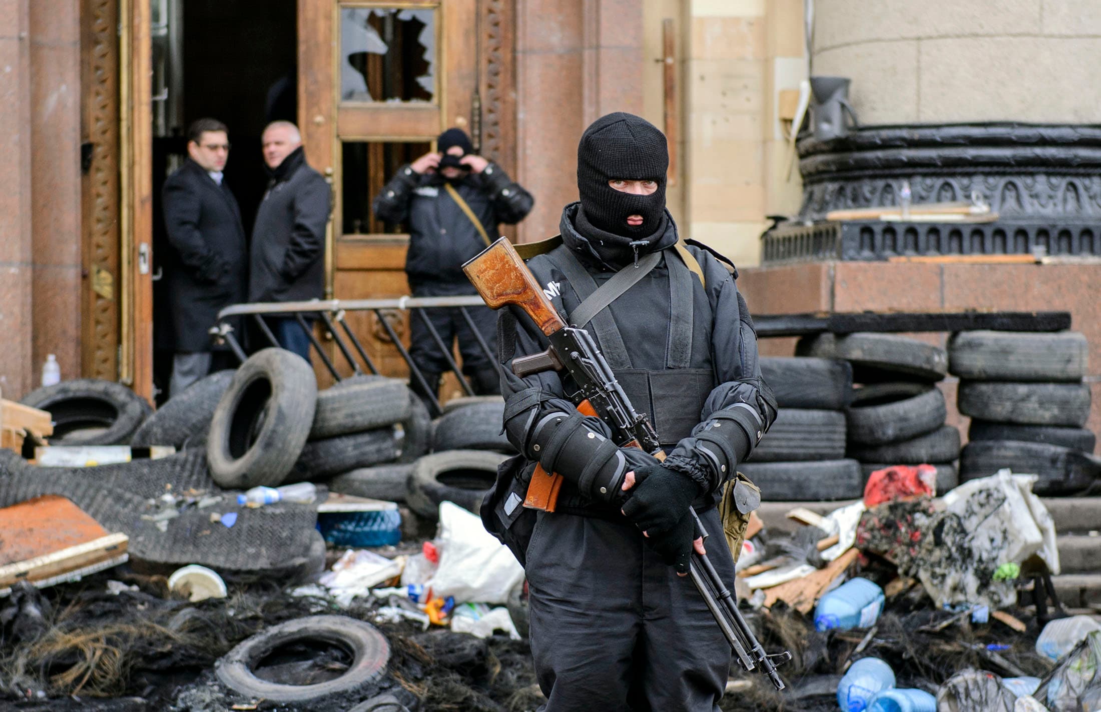 A masked armed man, representing Ukrainian special forces, stands guard outside the regional administration building in Kharkiv, April 8, 2014.