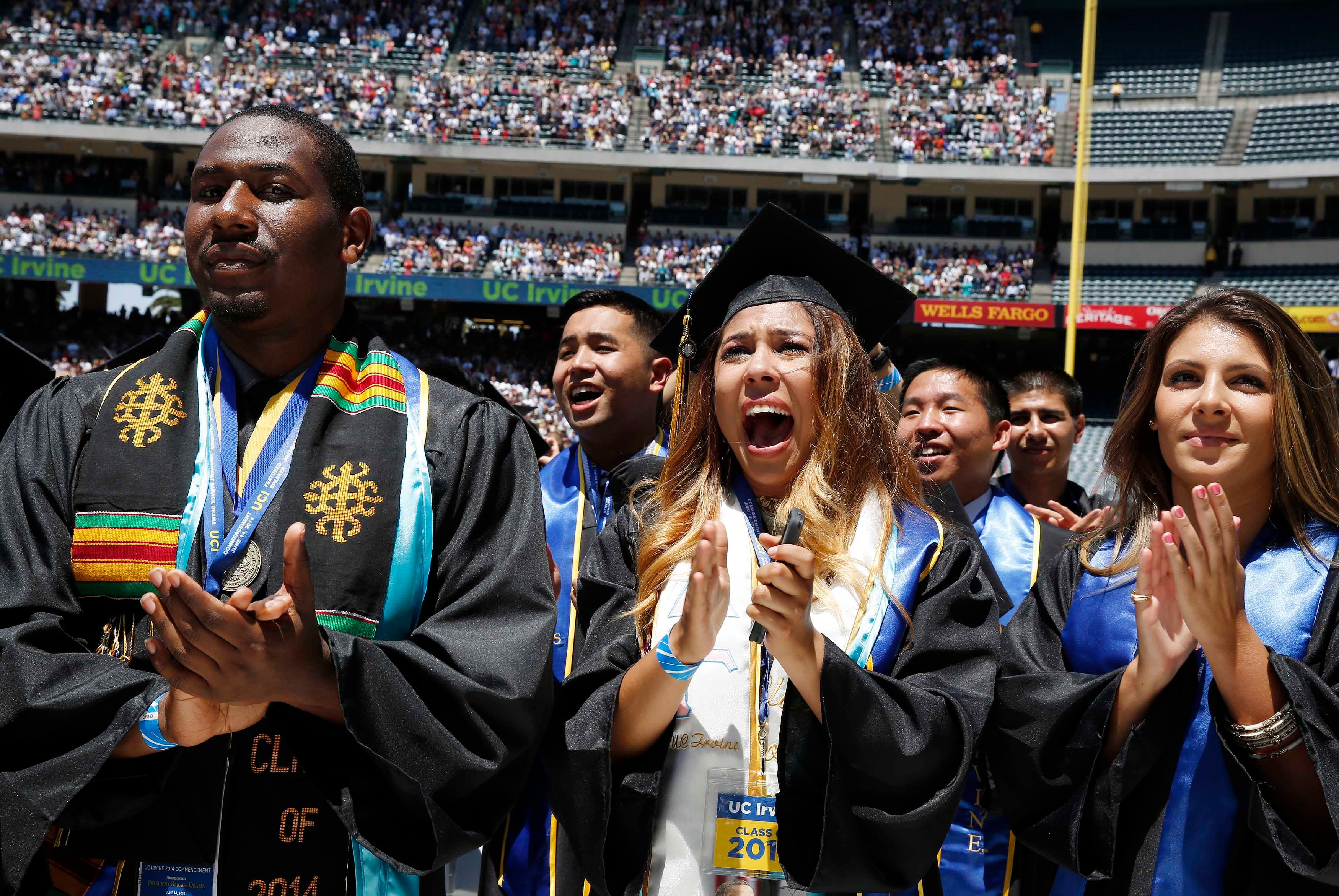 Students cheer as US President Barack Obama (not pictured) attends the 2014 commencement ceremony for the University of California, Irvine, while at Angels Stadium in Anaheim, California.