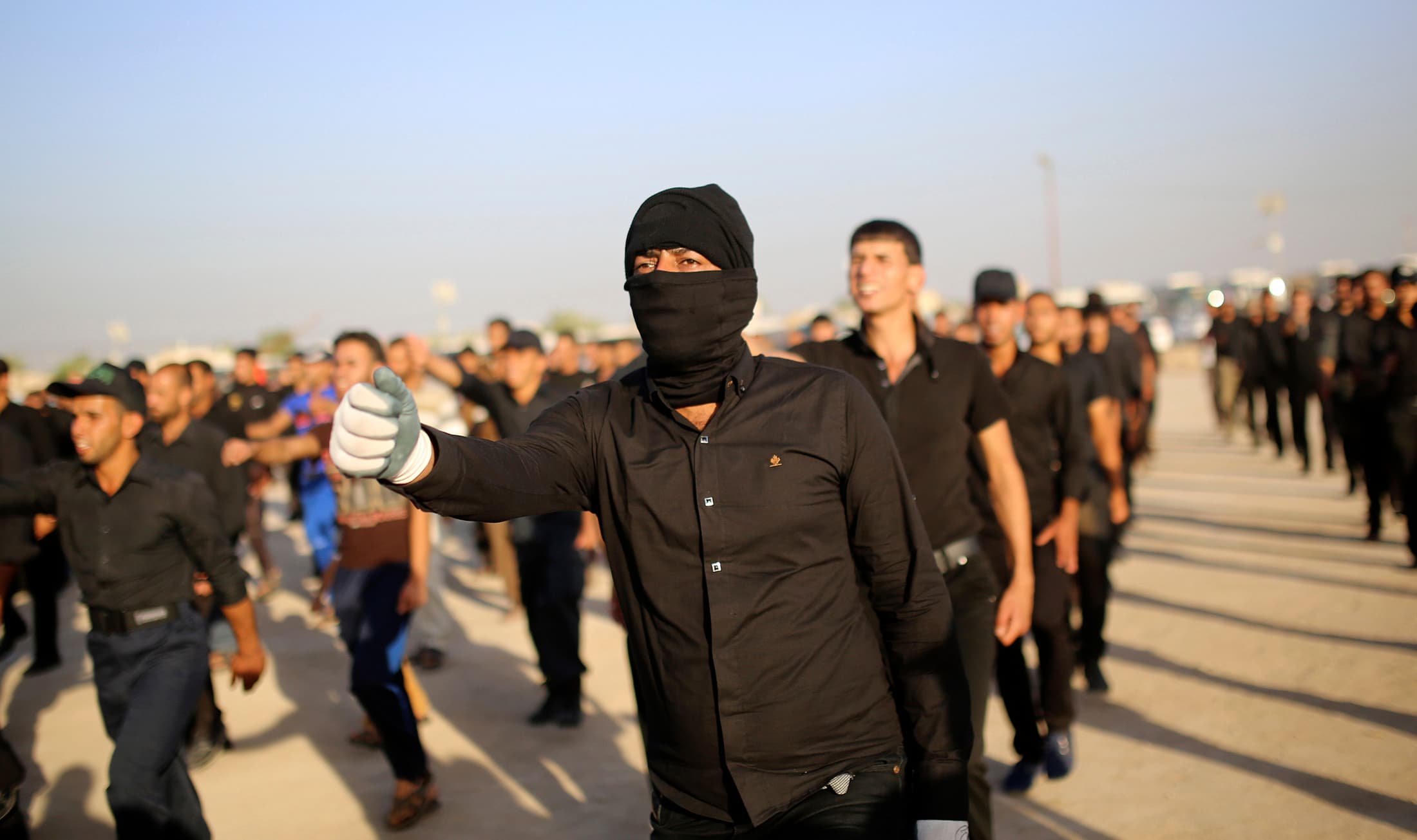 Mehdi Army fighters loyal to Shiite cleric Moqtada al-Sadr march during a military-style training in the holy city of Najaf, June 16, 2014.