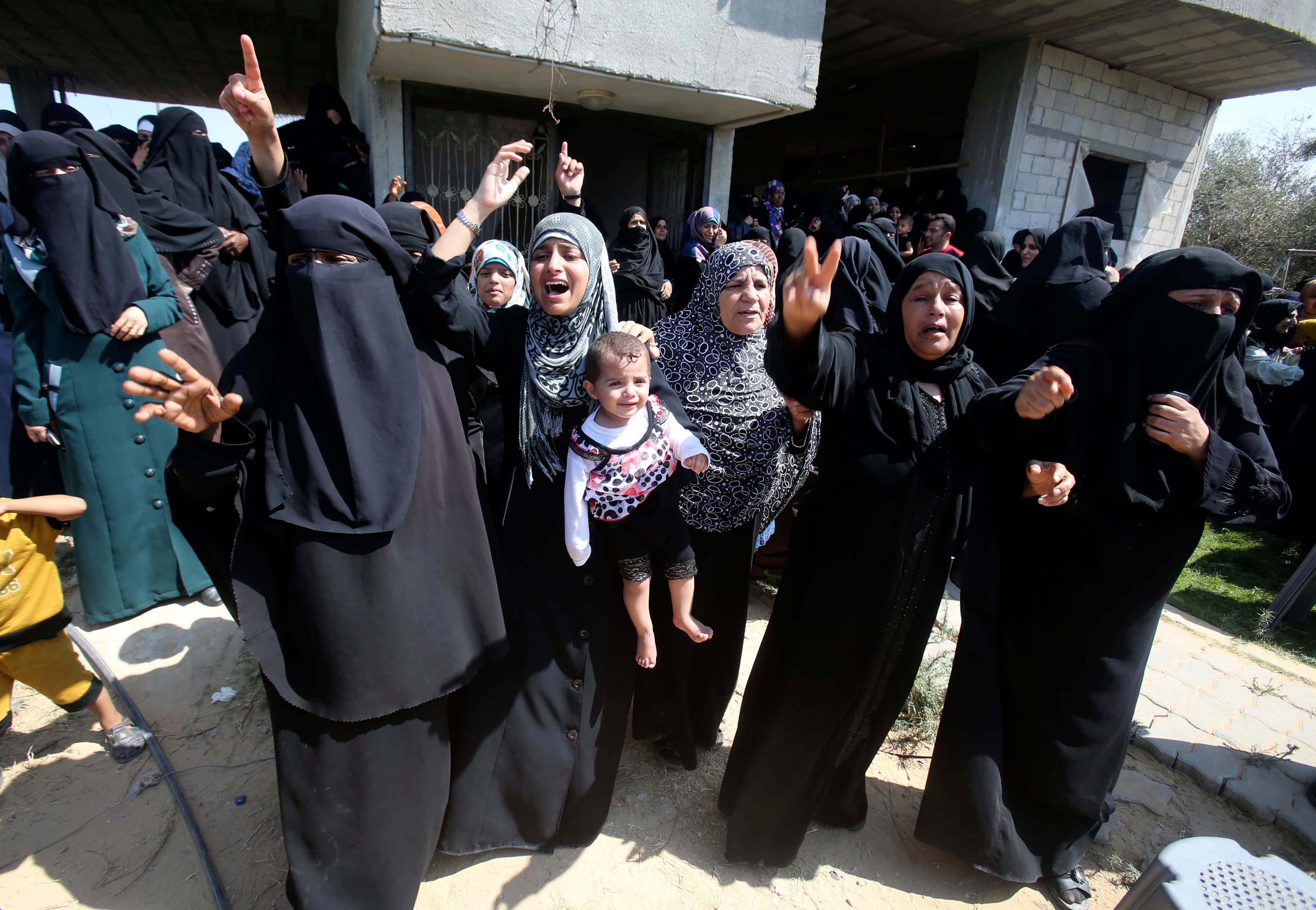 Relatives of a Palestinian Hamas militant mourn during his funeral in the southern Gaza Strip on July 7, 2014. The Israeli military killed at least five Hamas militants in air strikes carried out in the Palestinians enclave.