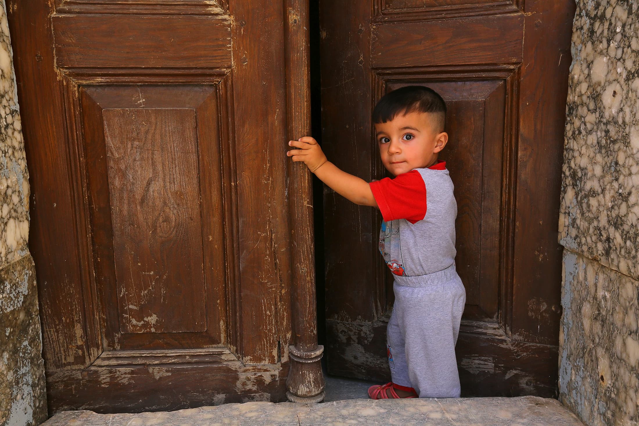An Iraqi Christian boy fleeing the violence in the Iraqi city of Mosul, stands inside the Church  in Telkaif, near Mosul.