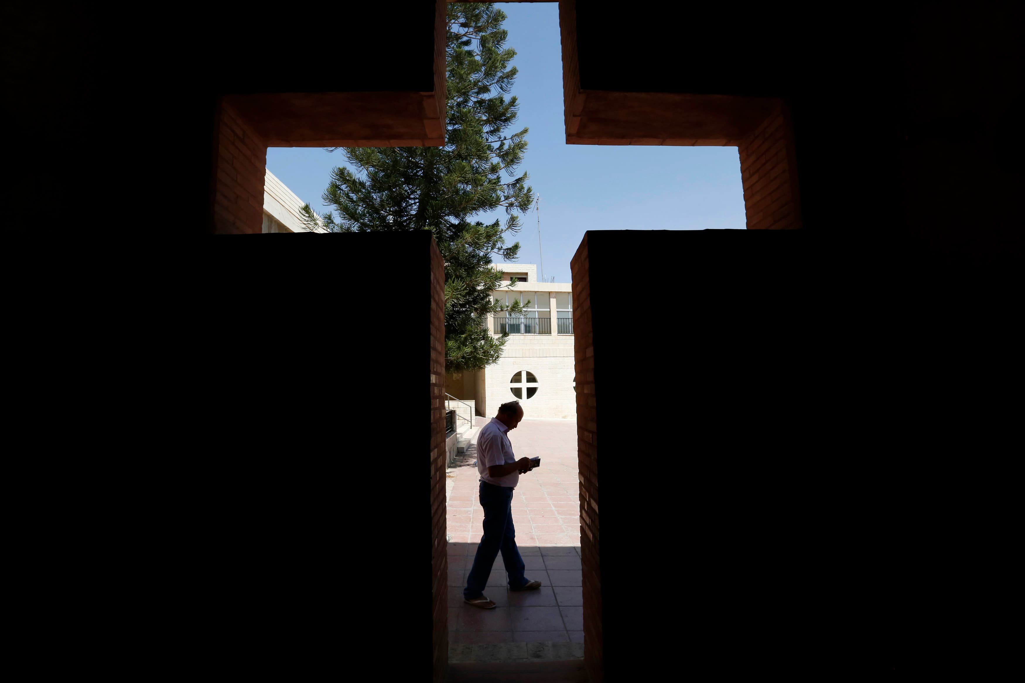 An Iraqi Christian man from Mosul, who fled from violence in northern Iraq, reads a book at the Latin Patriarchate Church in Amman, Jordan, on August 21, 2014.