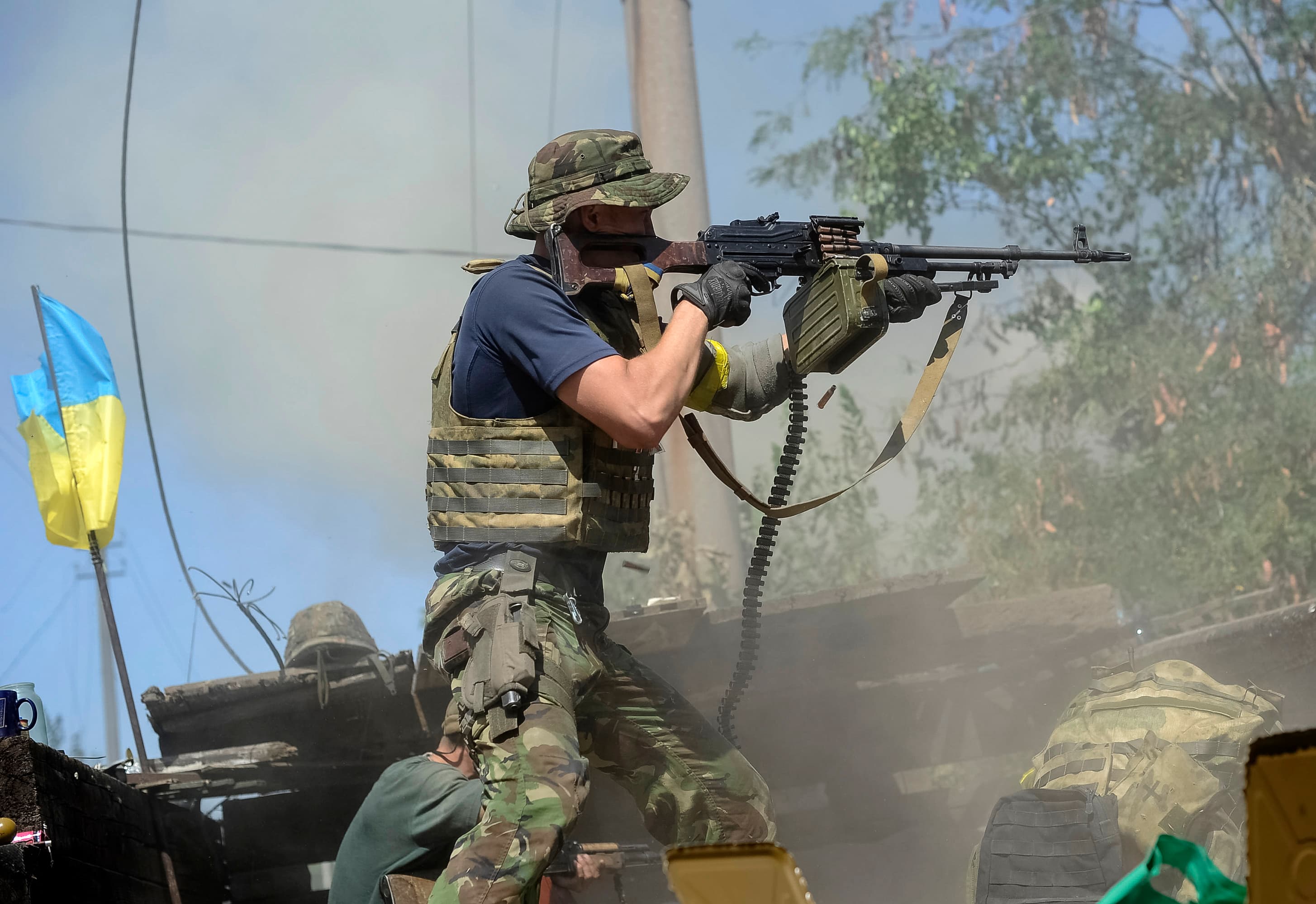 A Ukrainian serviceman fires at pro-Russian separatists in the eastern Ukrainian town of Ilovaysk, Tuesday.