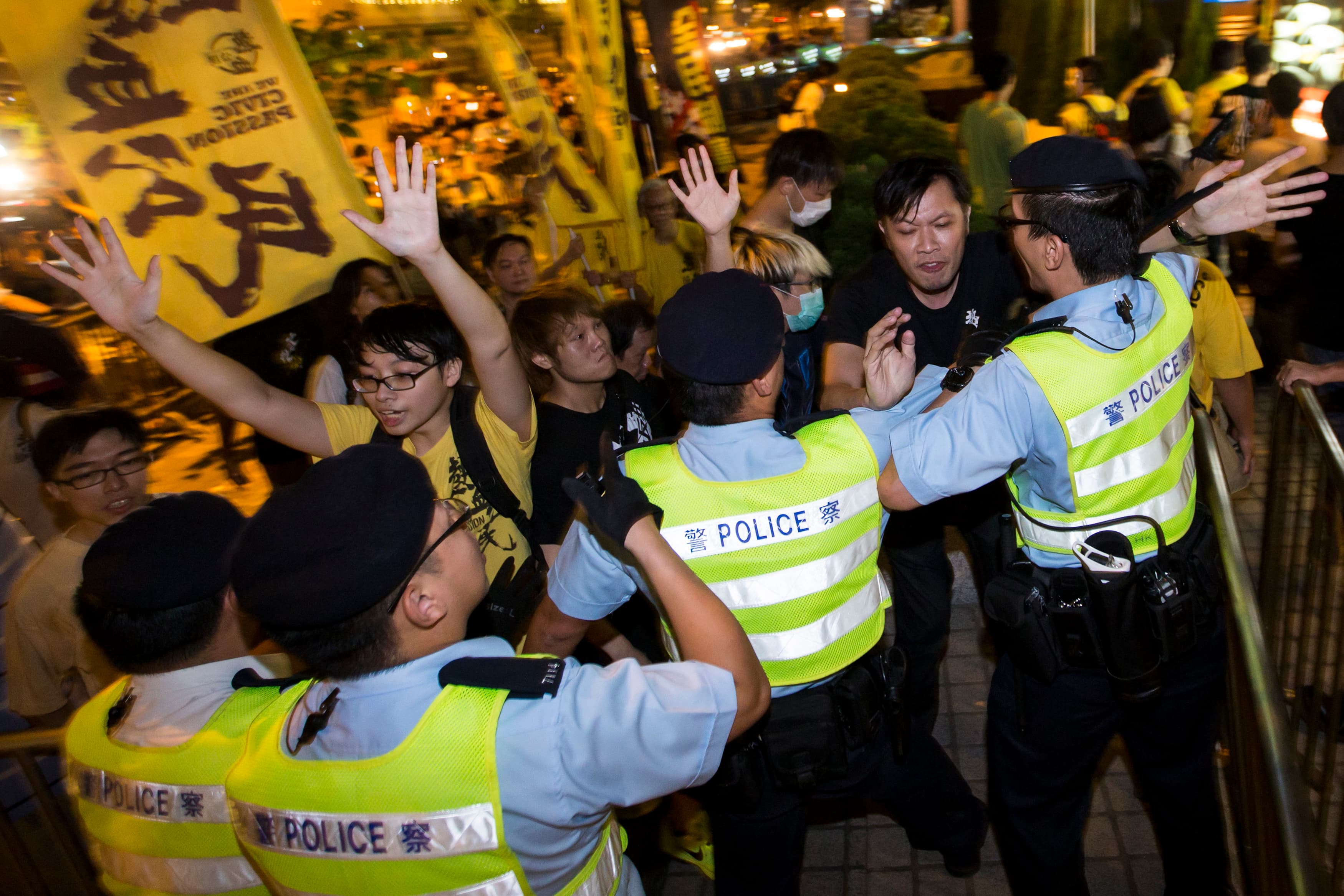 Pro-democracy activists clash with the police during a protest outside the hotel where China's National People's Congress (NPC) Standing Committee Deputy General Secretary Li Fei is staying in Hong Kong on September 1, 2014.