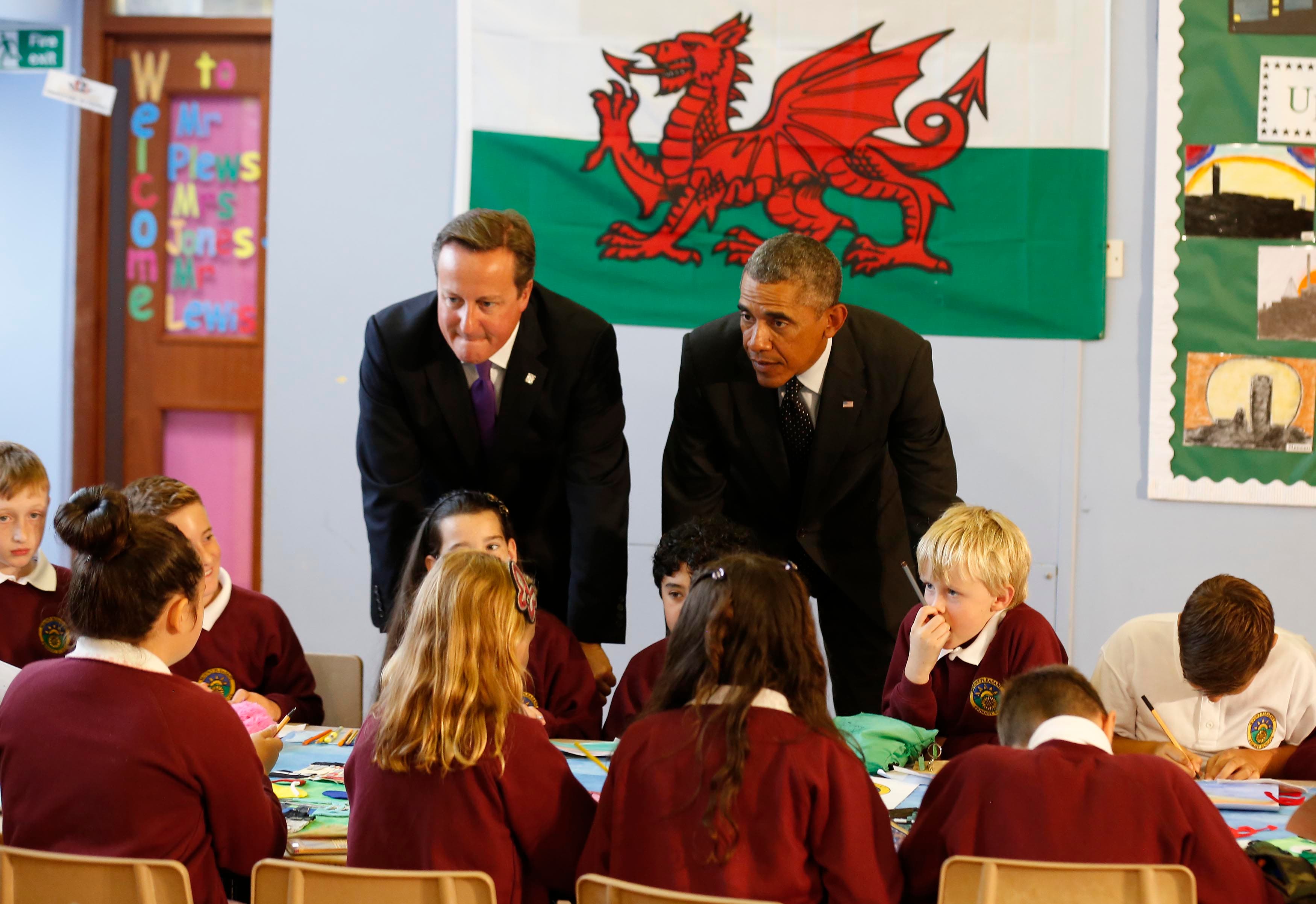 Barack Obama joins British Prime Minister David Cameron on a visit to a school prior to the NATO summit in Wales on Thursday. Western leaders are looking for strategies to deal with threats from Russia and the Islamic State.