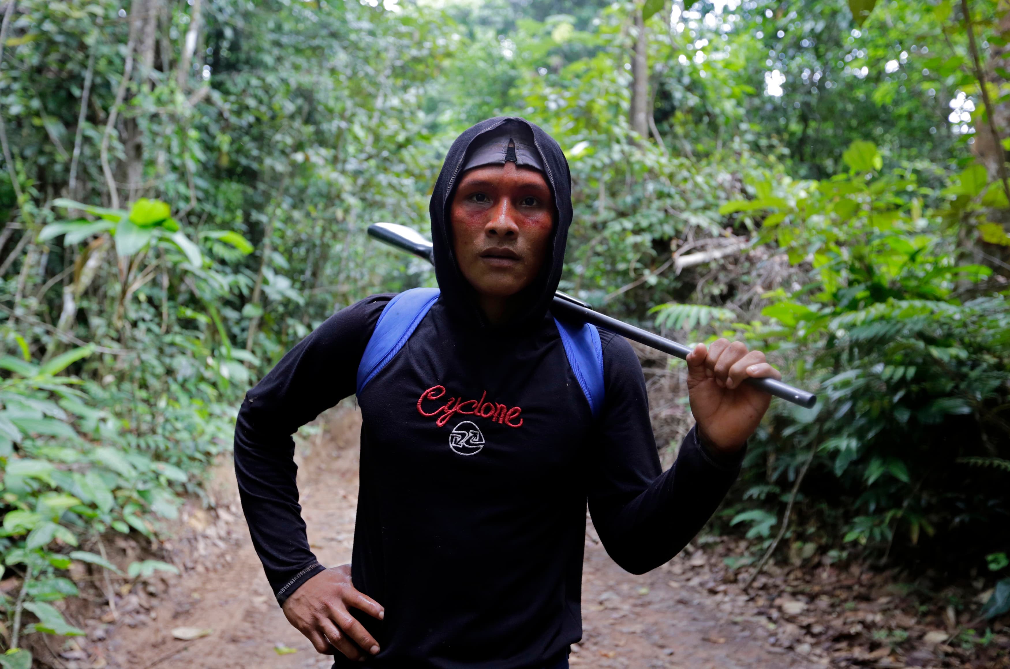 A Ka'apor Indian warrior stands holding a rifle during a jungle expedition to search for and expel loggers from the Alto Turiacu Indian territory