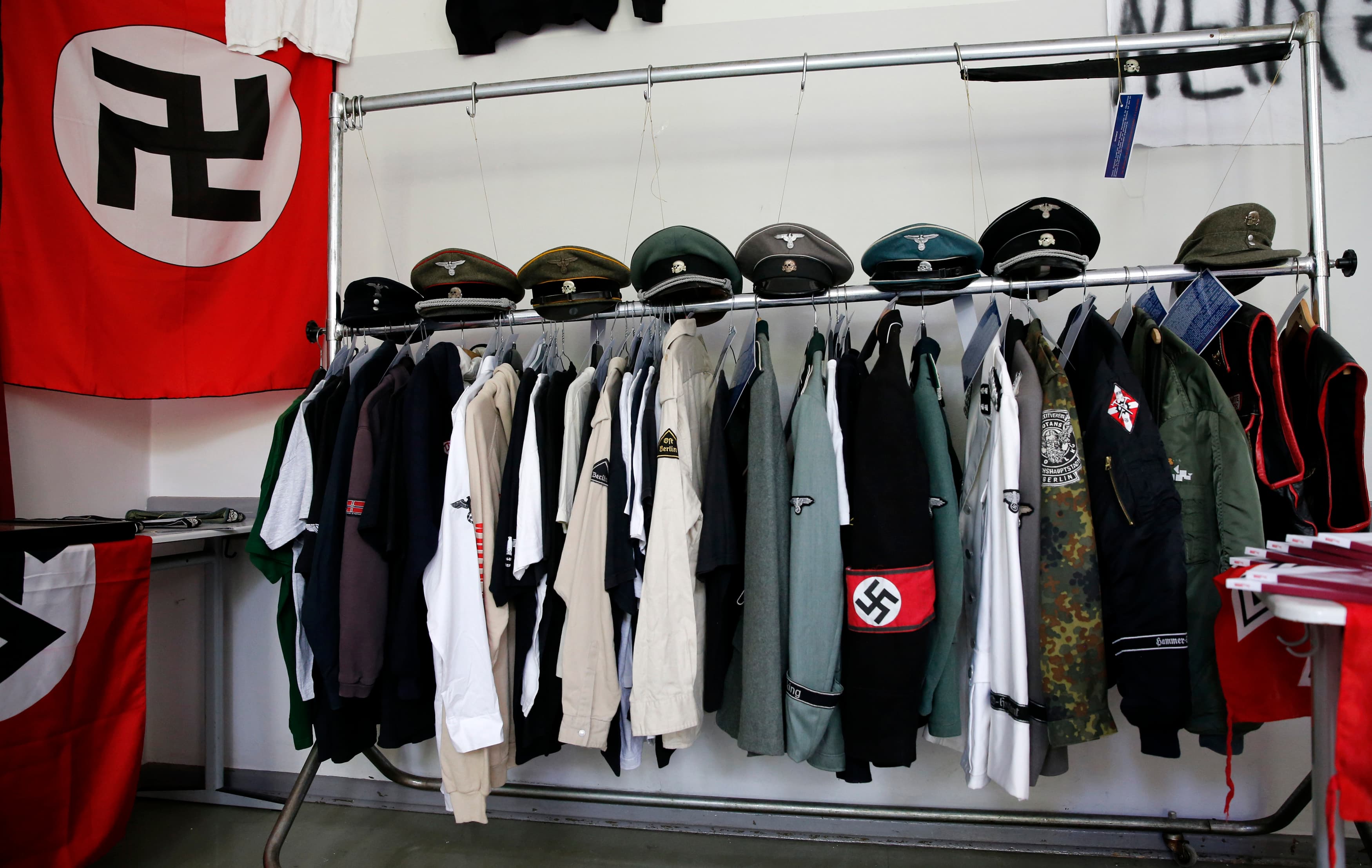 Nazi uniforms and a Swastika flag that were confiscated by the Berlin police during raids against German neo-Nazis are presented to the public during an open day at a police barracks in Berlin, September 7, 2014.