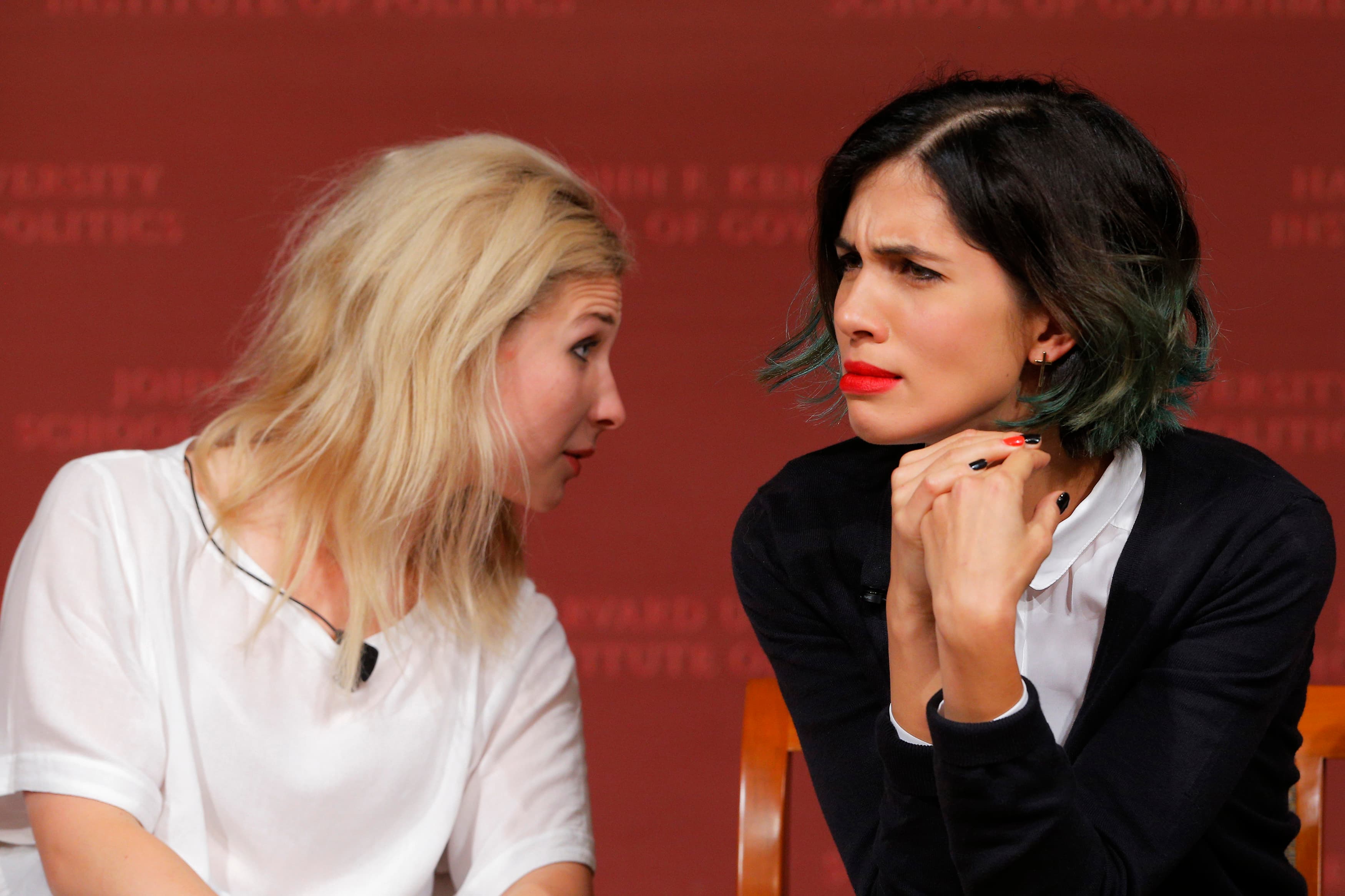Maria Alyokhina (L) and Nadezhda Tolokonnikova, members of the punk collective Pussy Riot, listen to a question from the audience during a forum at Harvard's Kennedy School of Government, a few days before they made an appearance in Ann Arbor, MI.