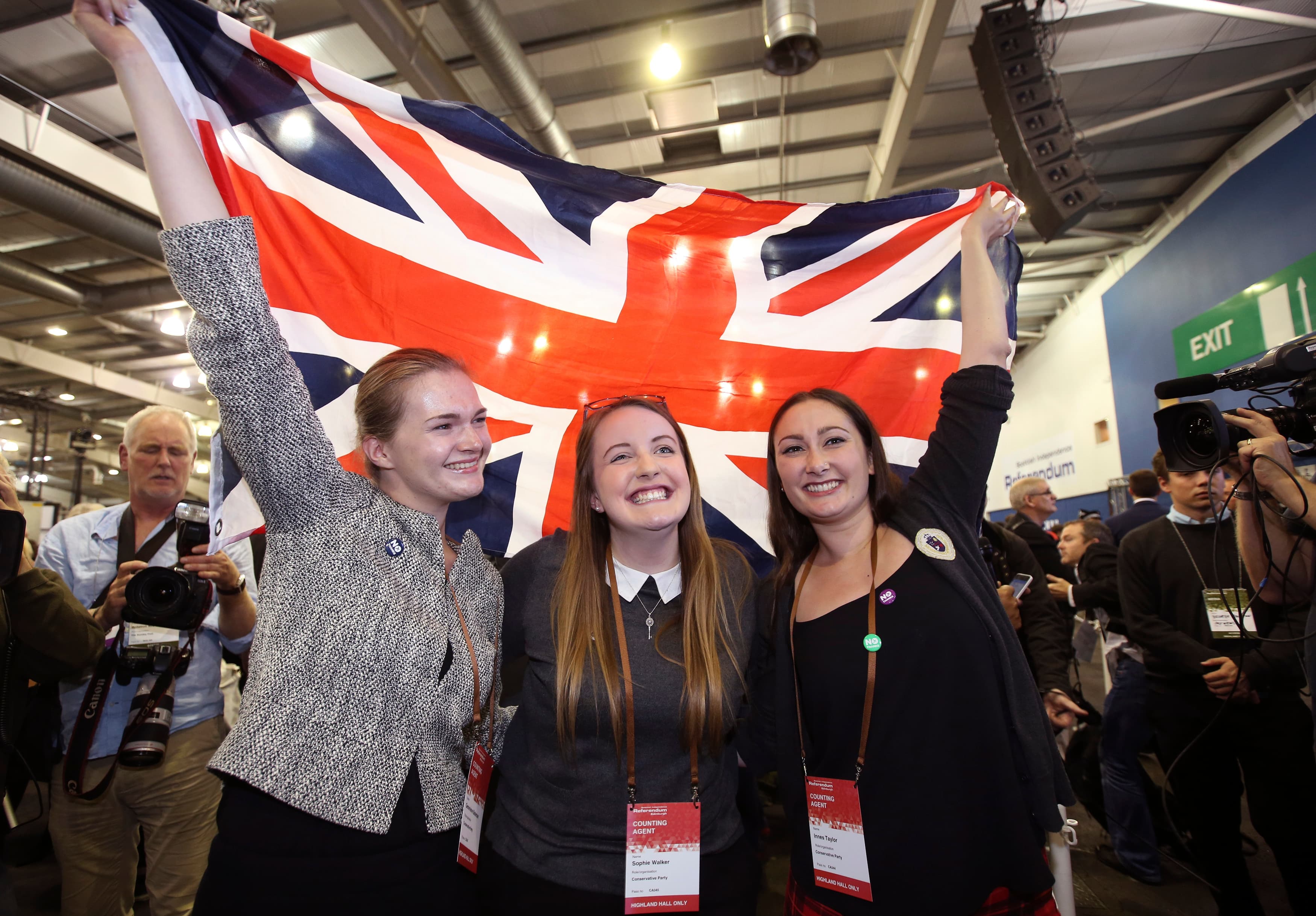 Scottish supporters from the "No" campaign celebrate as they hold up a Union flag in the city of Edinburgh.
