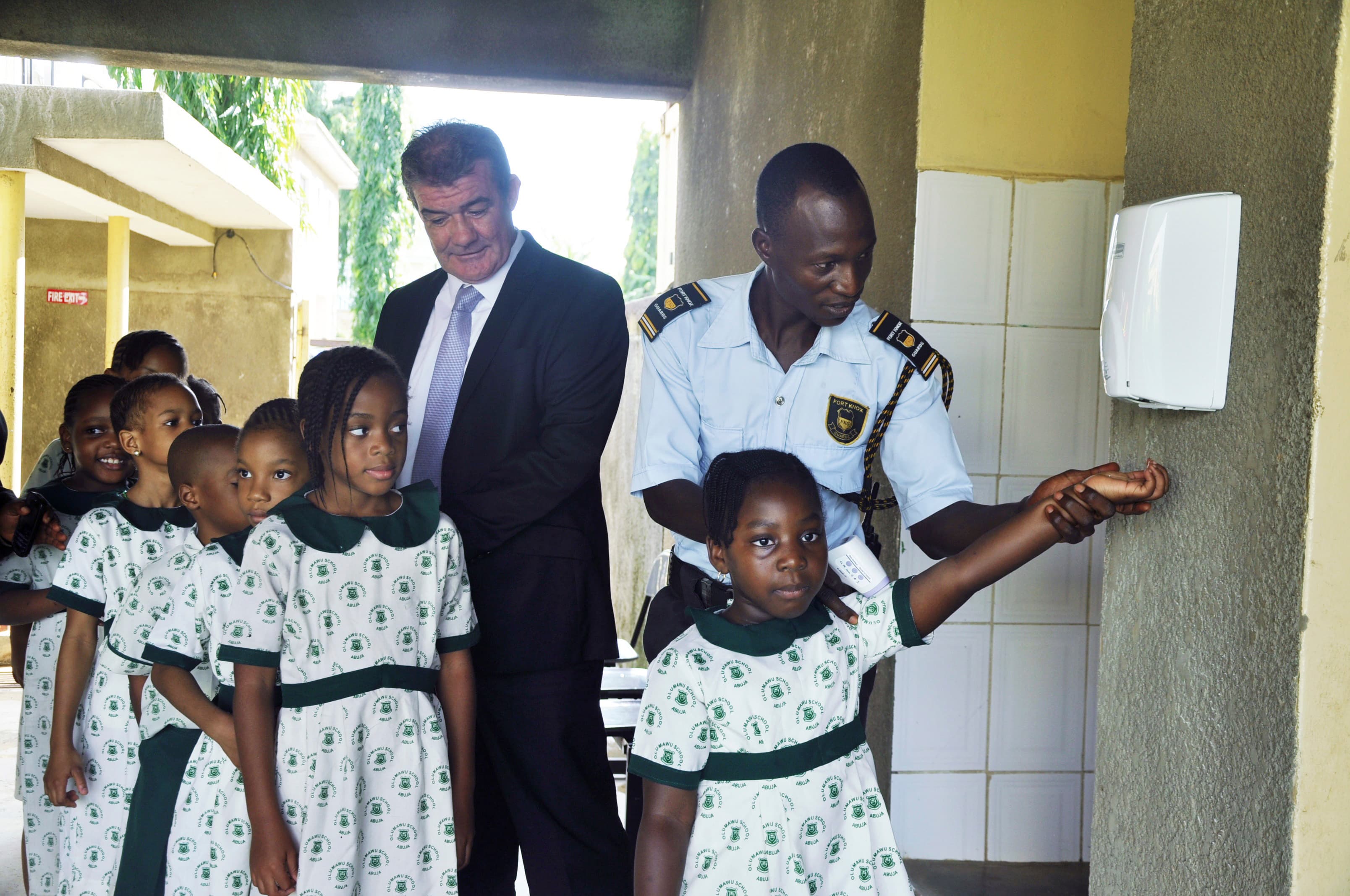 Pupils of Olumawu School in Nigeria are guided through the use of hand sanitizers. Nigeria is so far managing to halt the spread of Ebola.