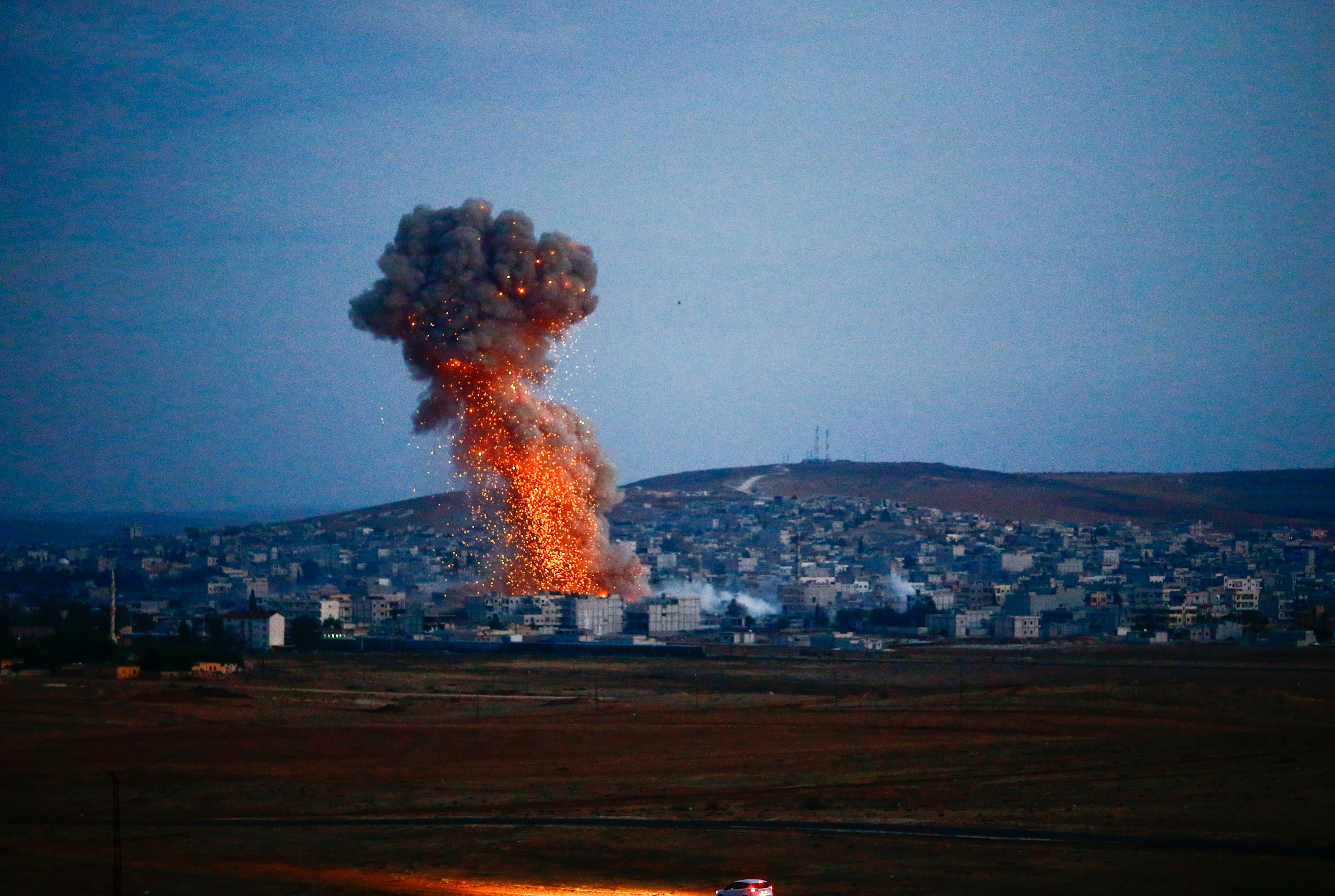 Smoke rises over Syrian town of Kobani after an airstrike, as seen from the Mursitpinar border crossing on the Turkish-Syrian border in the southeastern town of Suruc in Sanliurfa province, October 18, 2014.