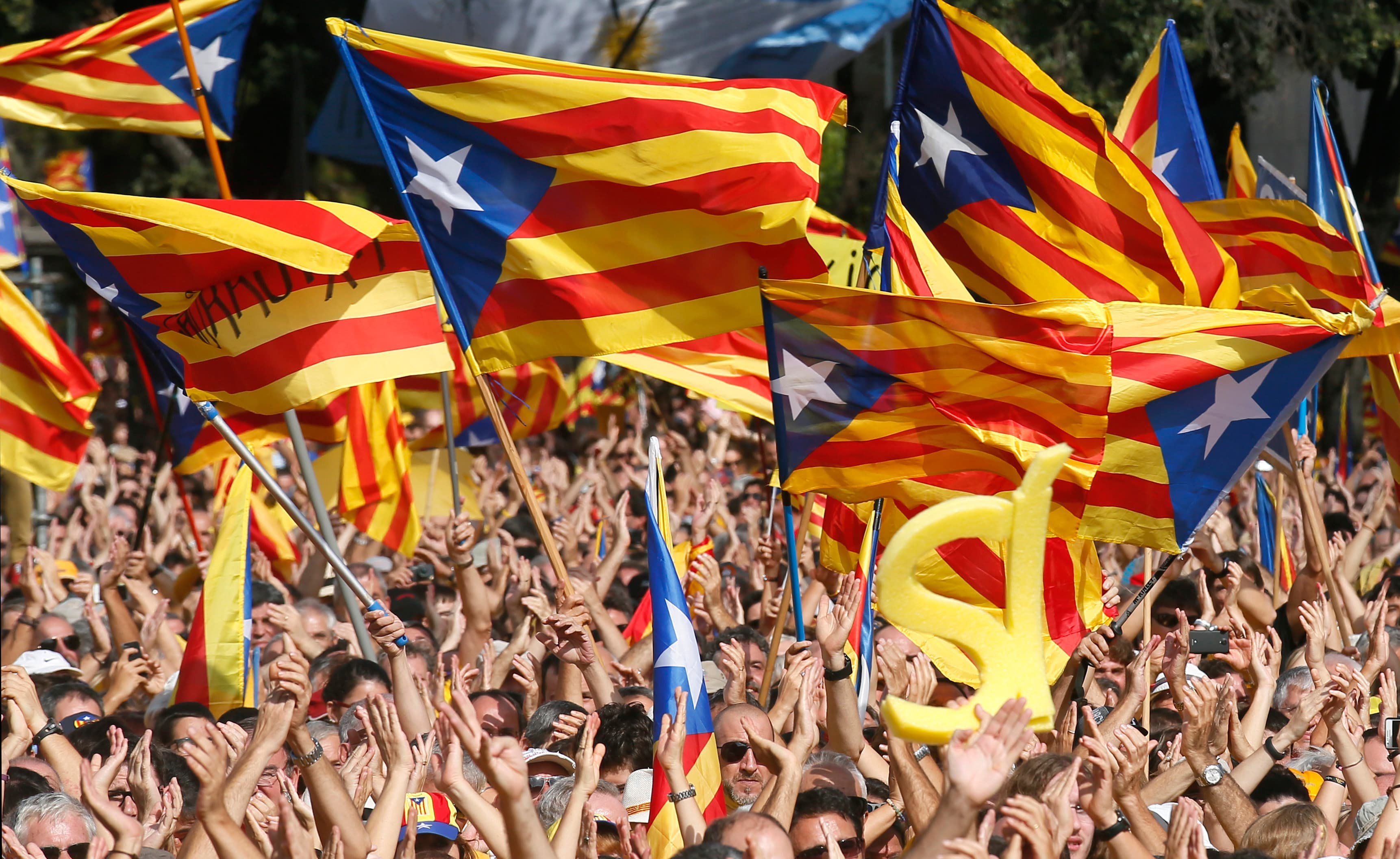 People wave Catalan separatist flags during a pro-independence demonstration at Catalunya square in Barcelona.