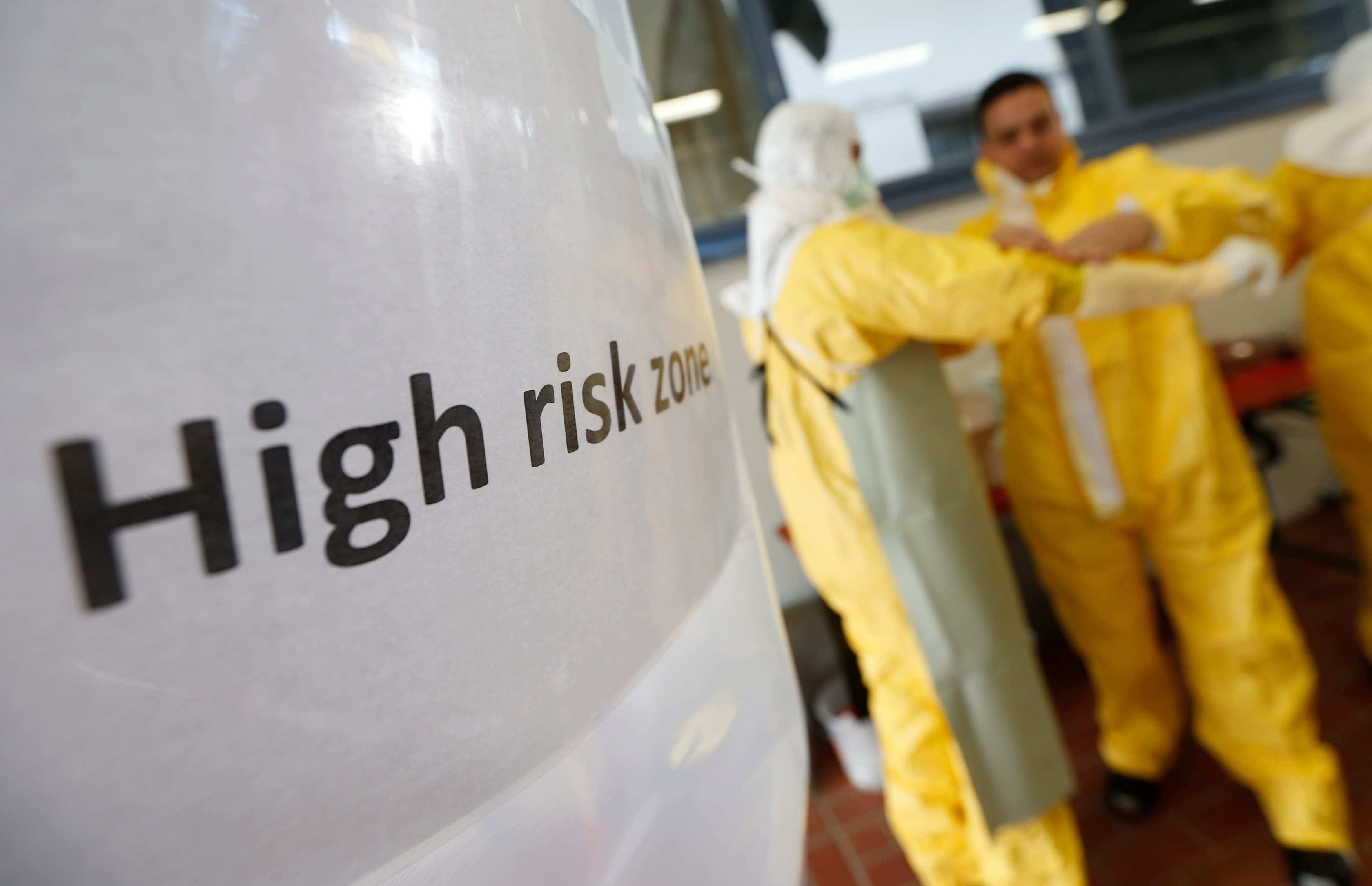 Volunteers put on protective suits during an Ebola training session held by Germany's Red Cross in Würzburg, on October 21, 2014