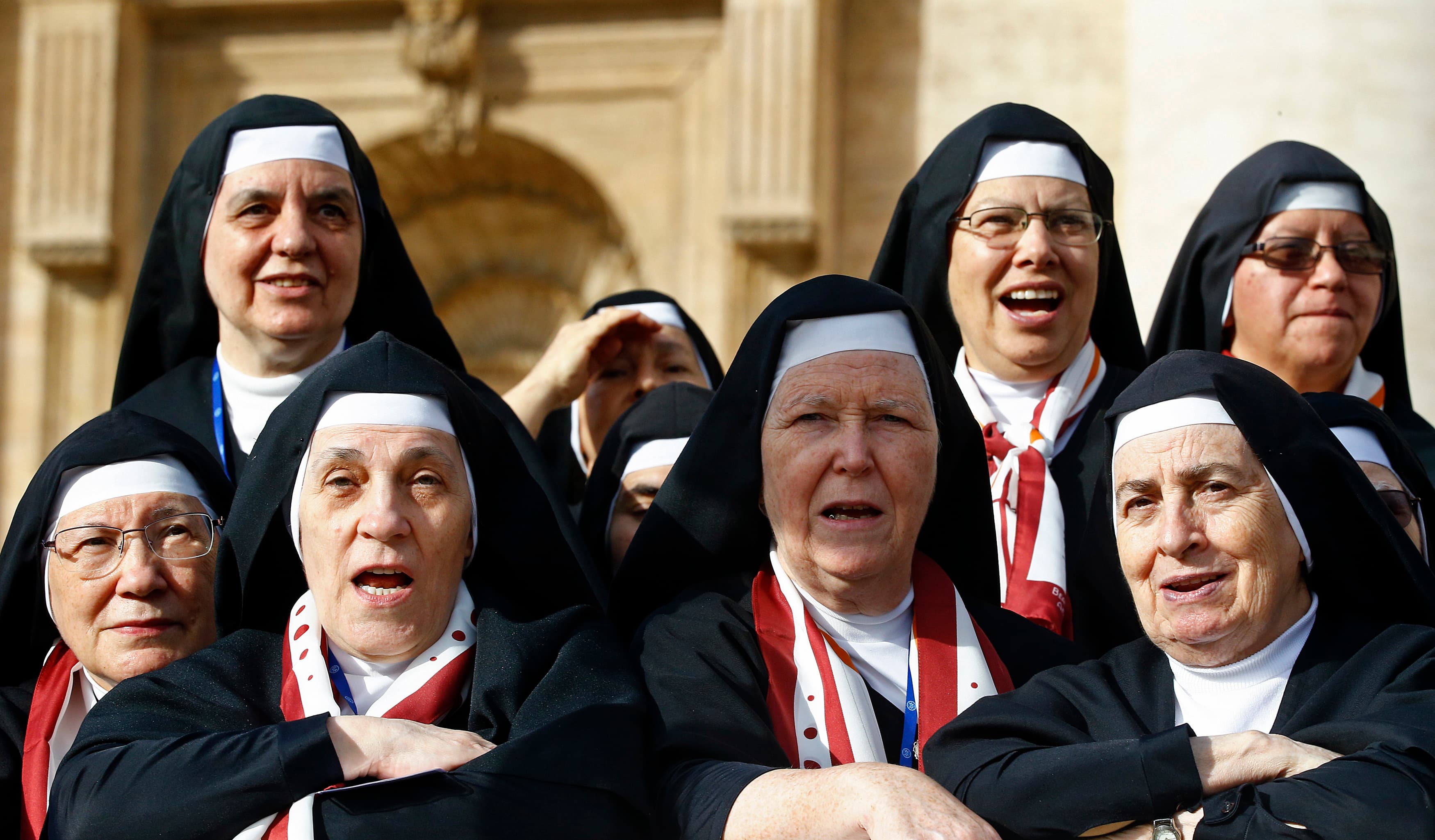 Nuns look on as Pope Francis arrives to lead his weekly audience in Saint Peter's Square at the Vatican on October 22, 2014.