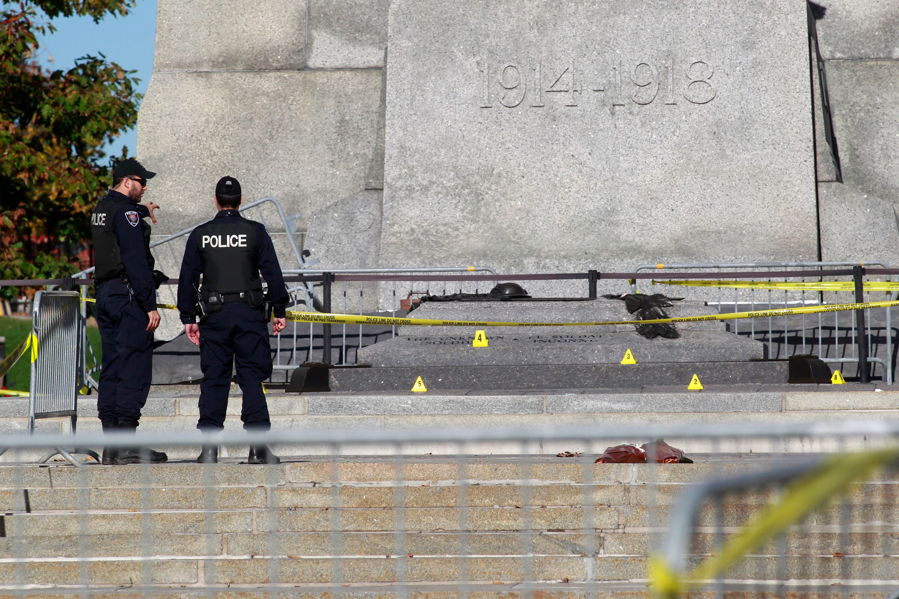 Police officers inspect the area around the National War Memorial in downtown Ottawa, where a Canadian soldier was shot and killed, on October 23, 2014.