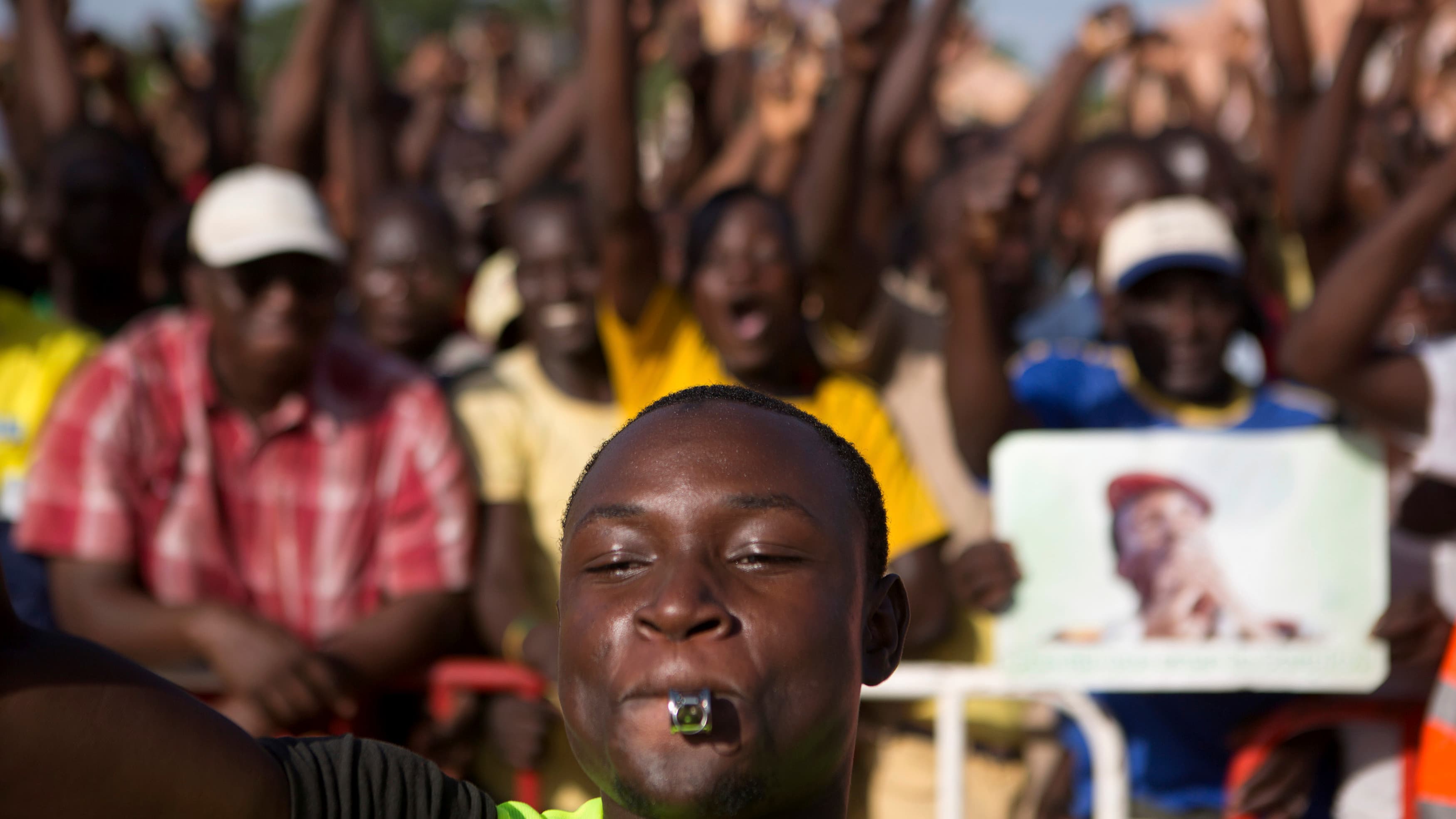 Protesters chant slogans at Place de la Nation in Ouagadougou, capital of Burkina Faso, on October 28, 2014. Police fired tear gas at rock-throwing protesters after tens of thousands of people marched through the city on Tuesday morning.