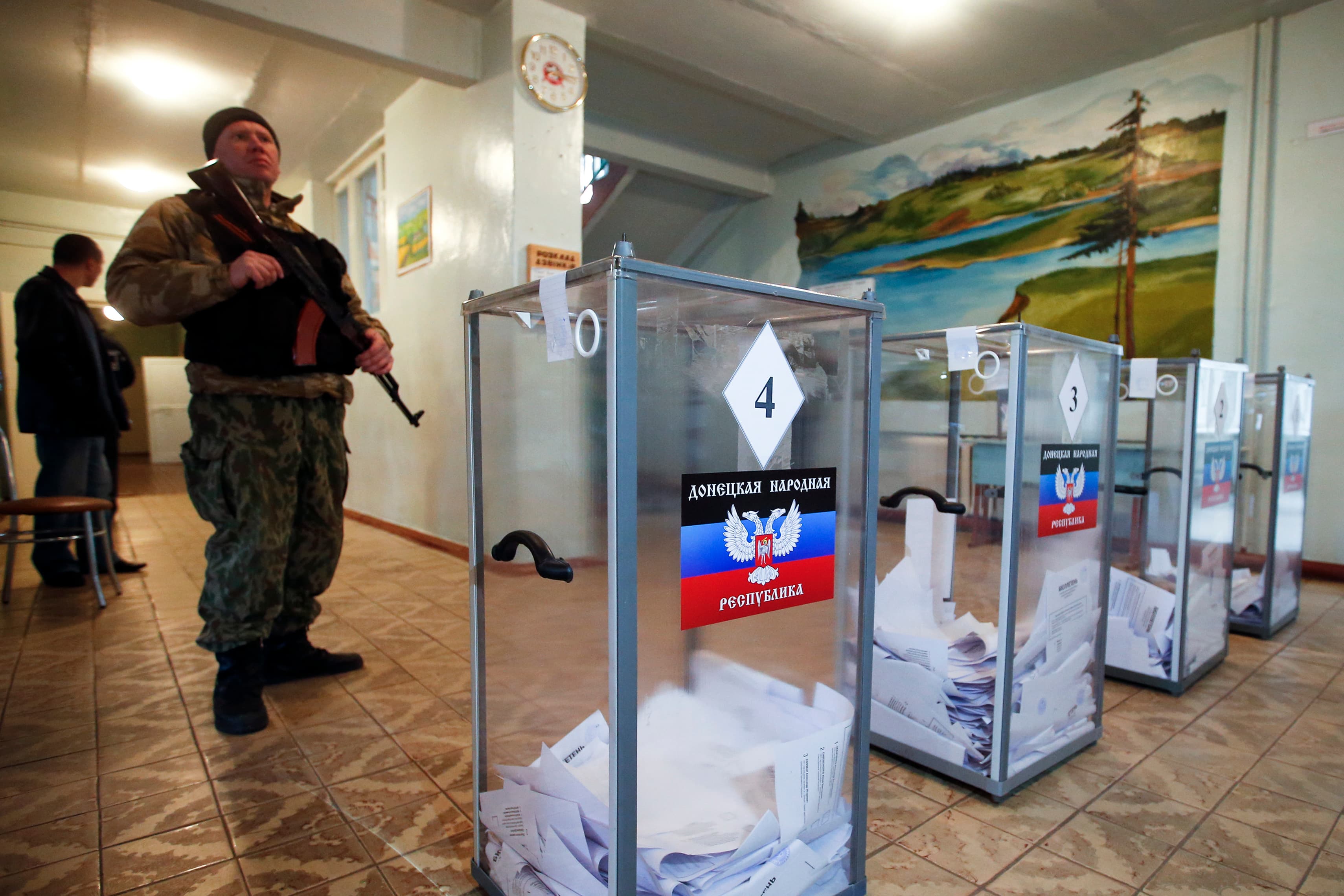 A pro-Russian separatist stands guard during the self-proclaimed Donetsk People's Republic leadership and local parliamentary elections on Sunday.
