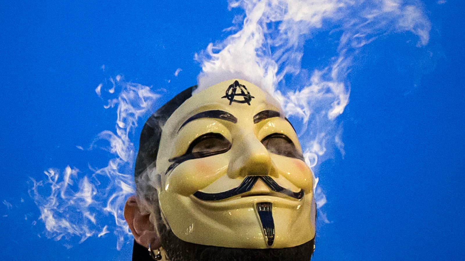 A man in a Guy Fawkes mask smokes while joining supporters of the Anonymous movement taking part in the global "Million Mask March" protests in New York, on November 5, 2014.
