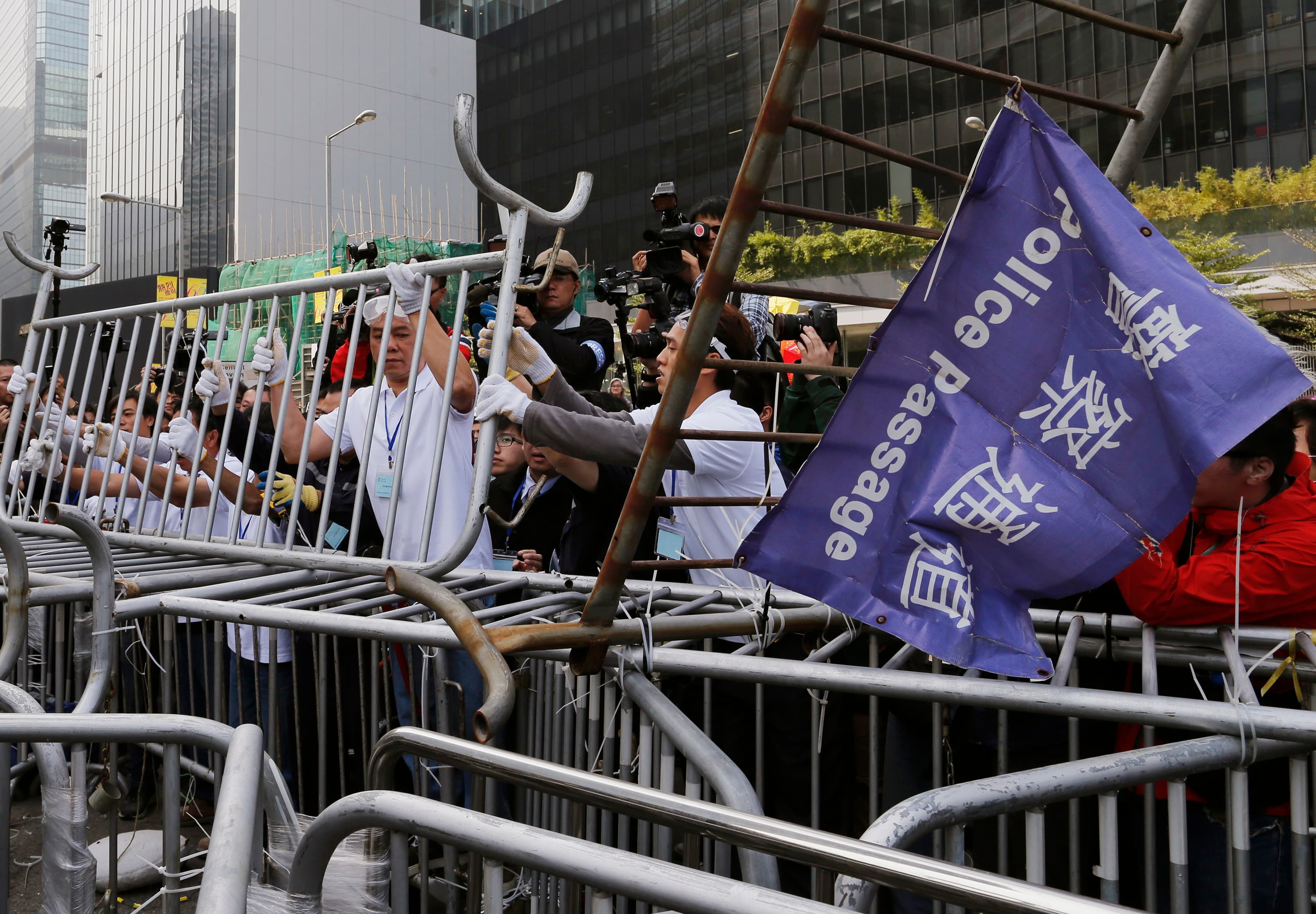 Pro-democracy protesters dismantle a barricade, in accordance with a court injunction to clear part of the protest site. The demonstrators set up camp at the end of September 2014.