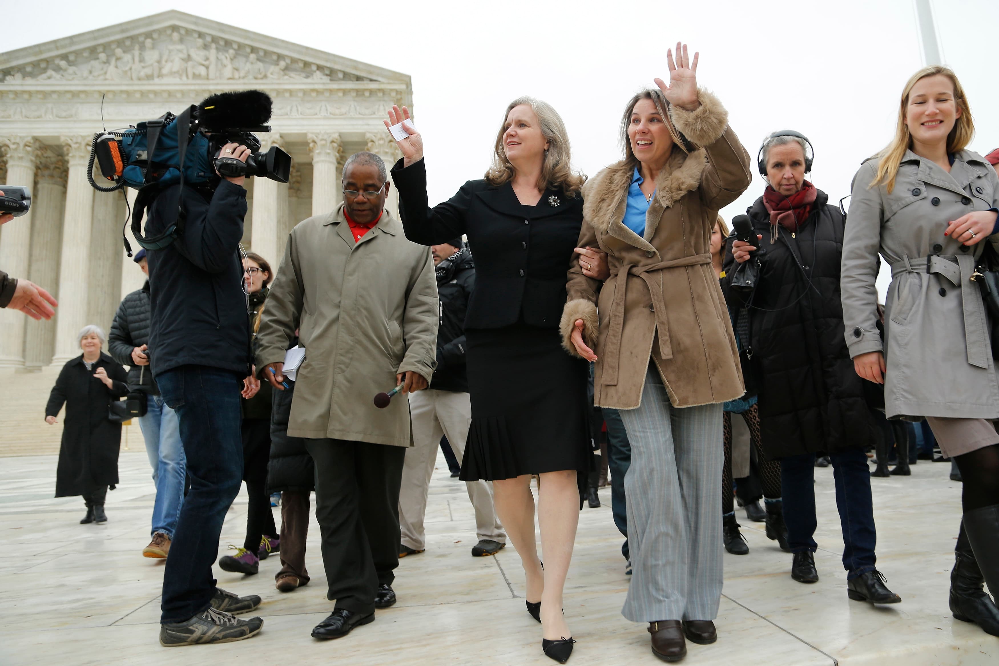 Peggy Young (3rd R) and her attorney Sharon Gustafson (4th R) wave to supporters as they depart the US Supreme Court building on December 3, 2014.