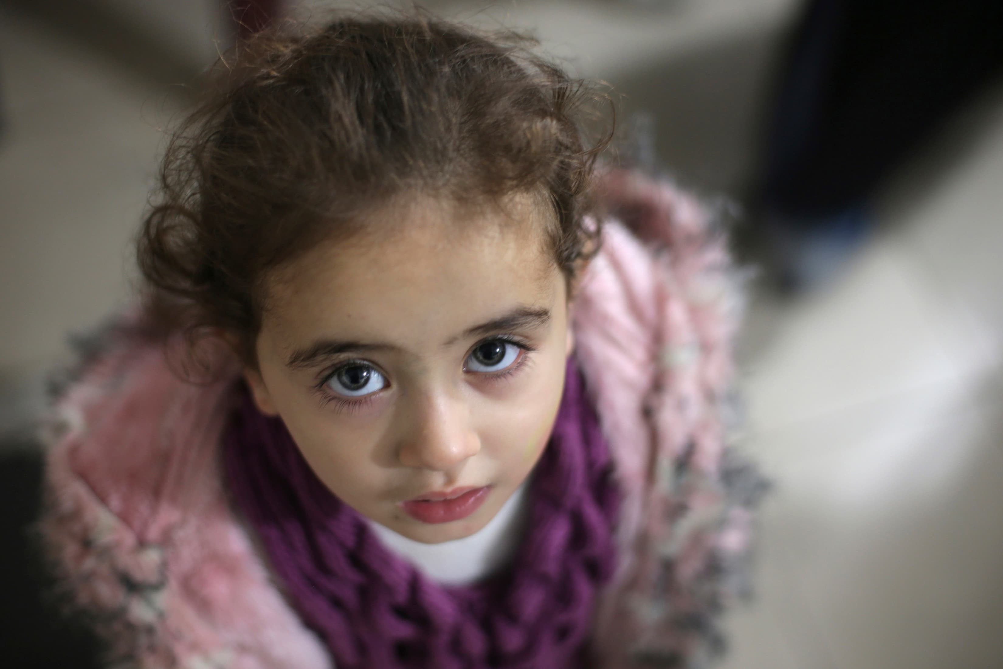 A Syrian child who lost both of her parents attends a gathering organized by a charity for orphans in Douma, near Damascus.