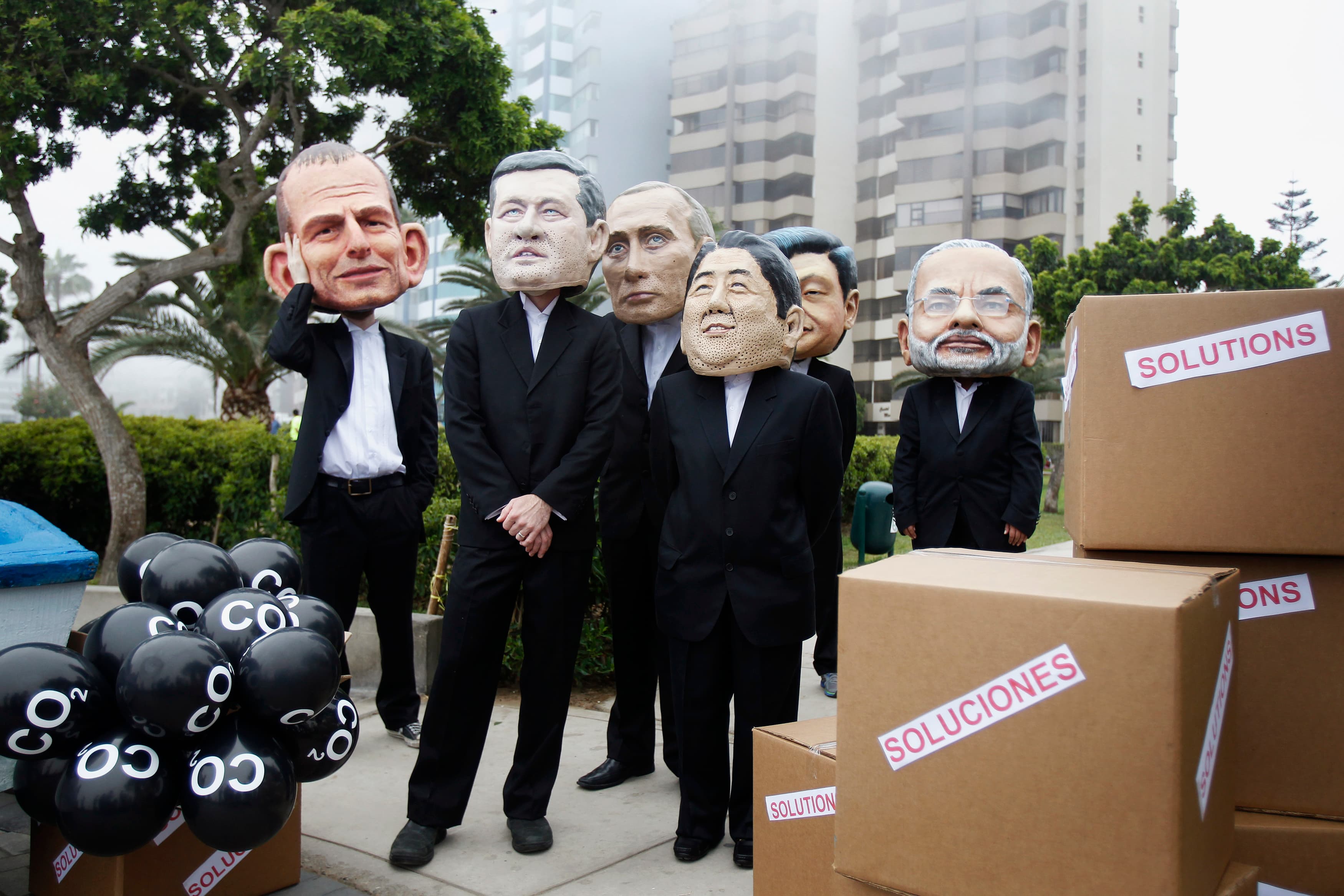 Activists wearing masks depicting Australia's Prime Minister Tony Abbott, Canada's Prime Minister Stephen Harper, Russia's President Vladimir Putin, Japan's Prime Minister Shinzo Abe, China's President Xi Jinping and India's Prime Minister Narendra Modi d