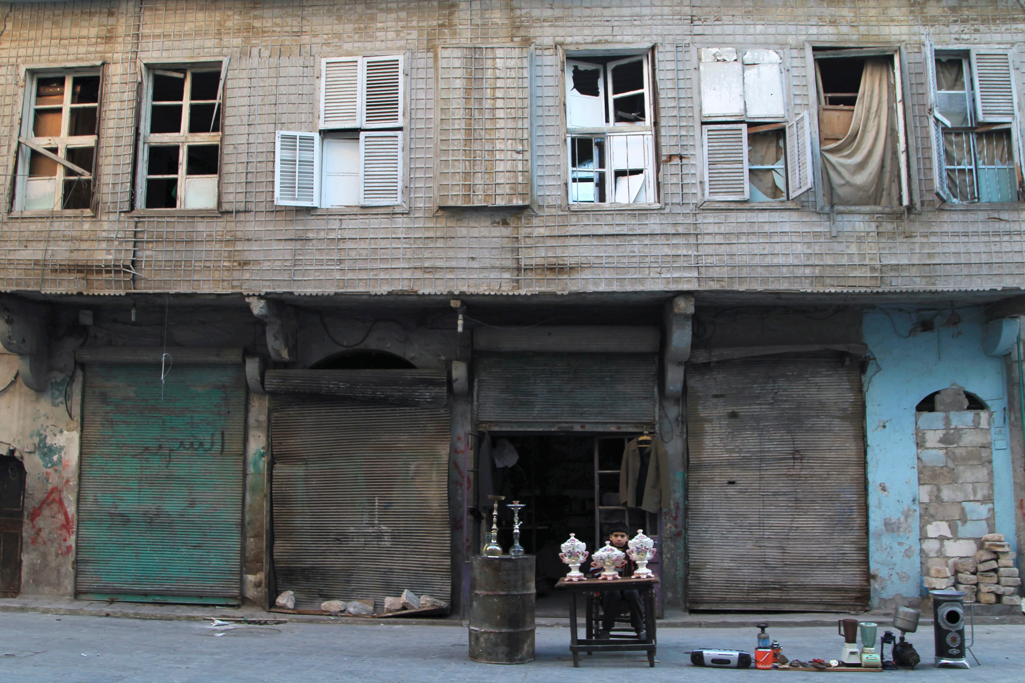 A boy selling antiques in Old Aleppo, January 2015. Archaeological treasures, thousands of years old, are being openly looted and traded In Syria and neighboring nations.