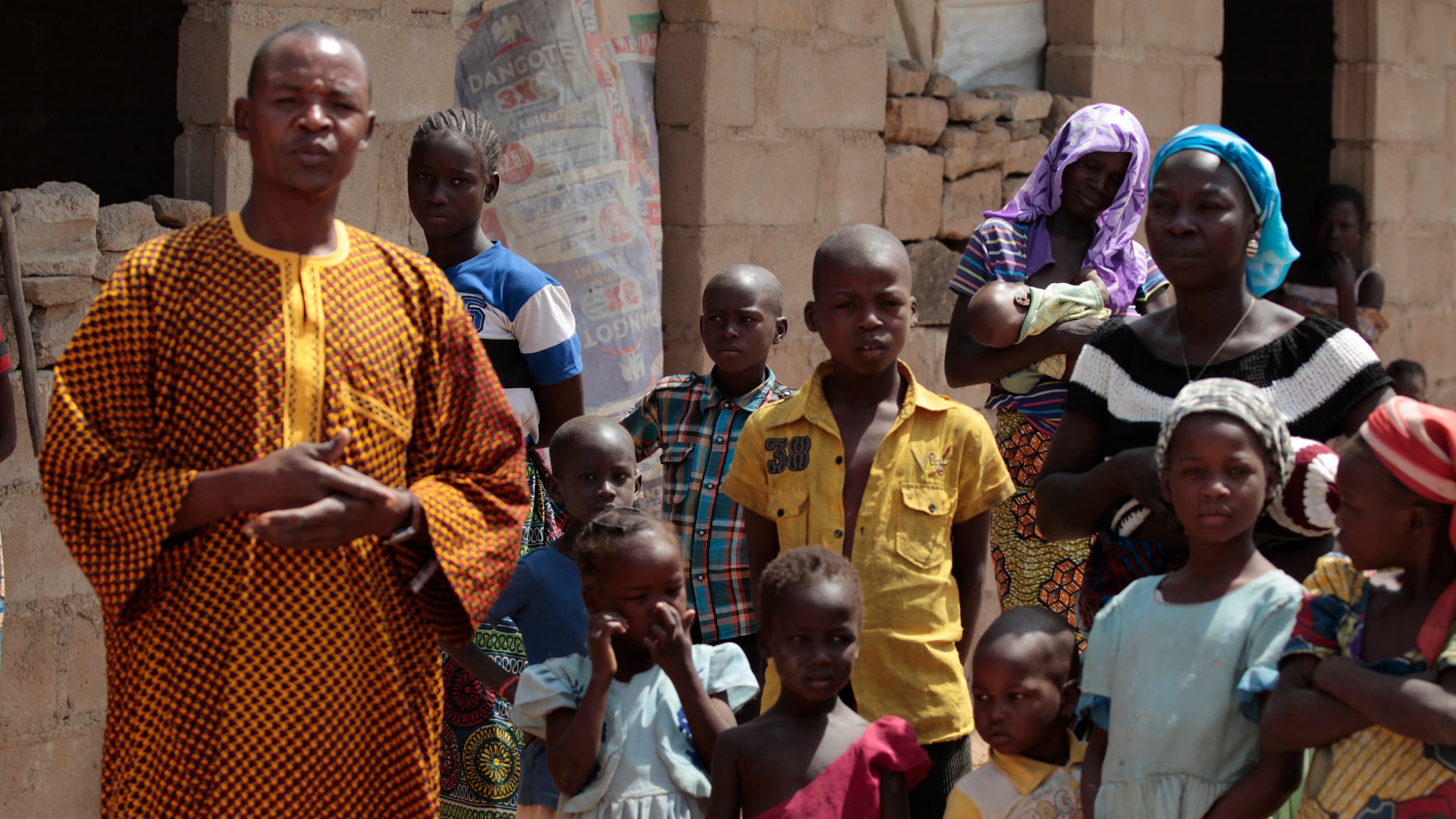 A family that escaped Boko Haram attacks in both Michika and Cameroon seek shelter in an uncompleted house in Adamawa on January 31, 2015.