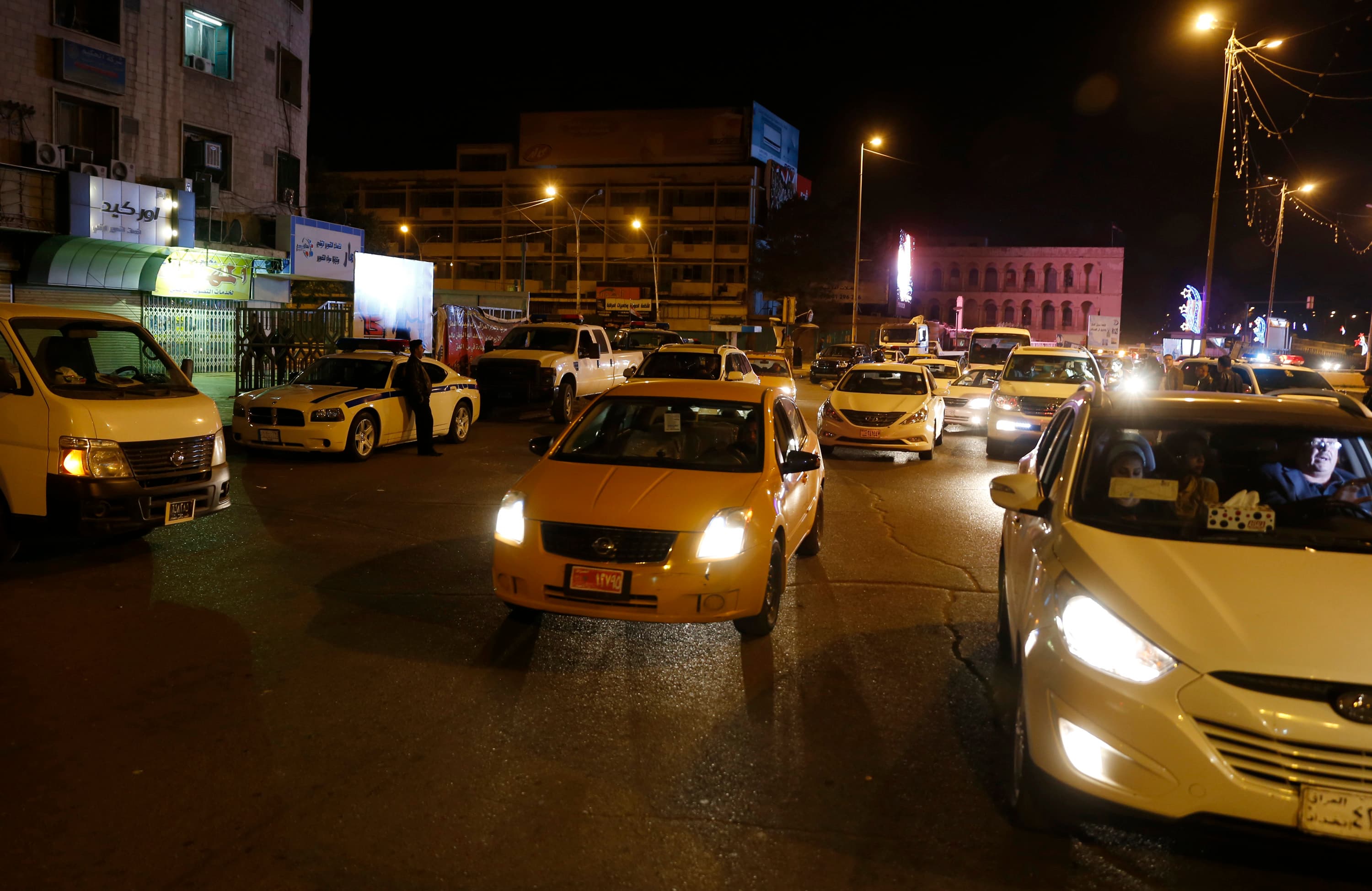 Vehicles are seen on a street in Baghdad as the Iraqi government lifted a night-time curfew.  Officials hope to demonstrate that Baghdad no longer faces a threat from Islamic State.