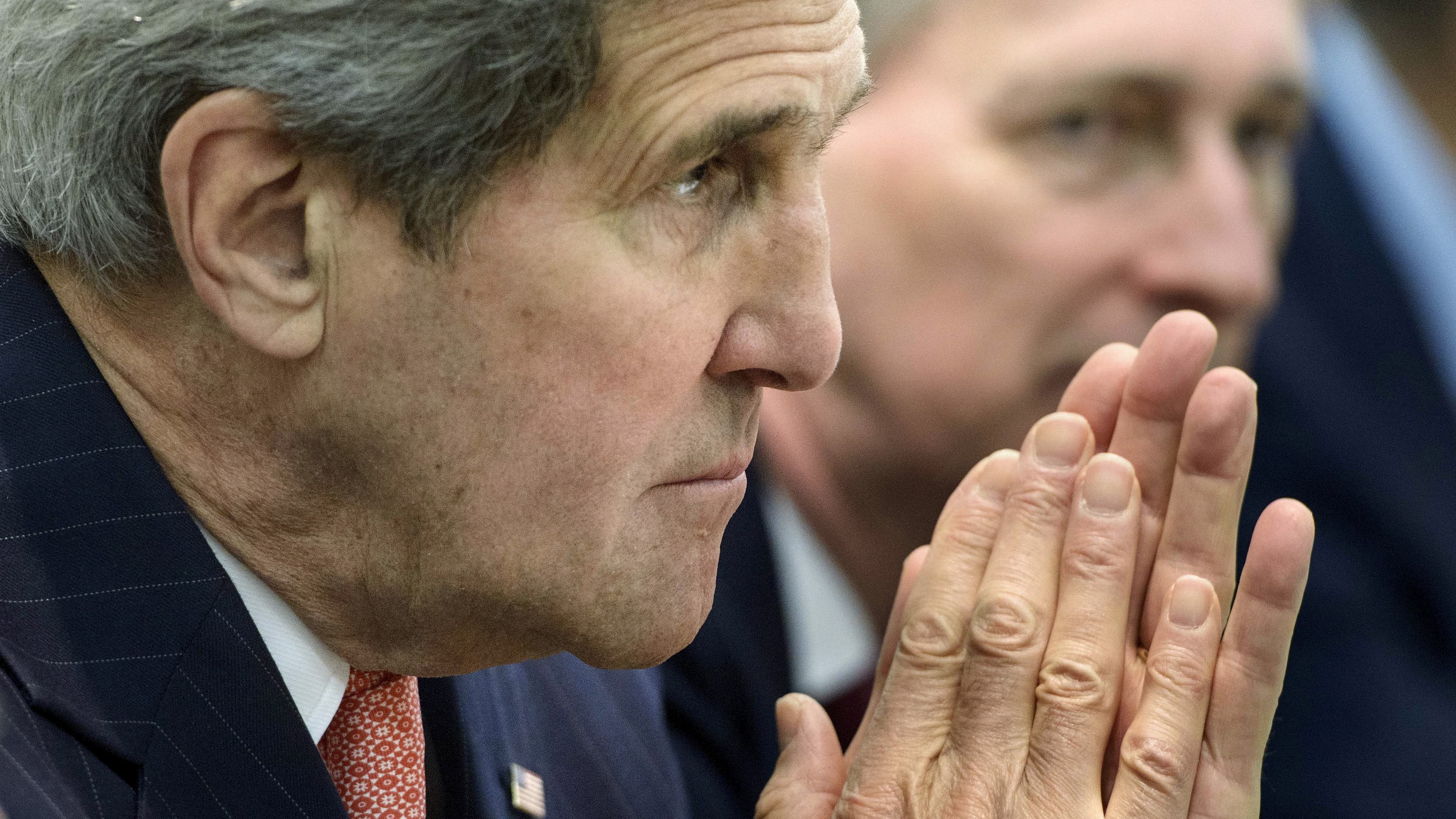 US Secretary of State John Kerry waits with others before a meeting with P5+1, European Union and Iranian officials in Lausanne, Switzerland, on March 30, 2015.