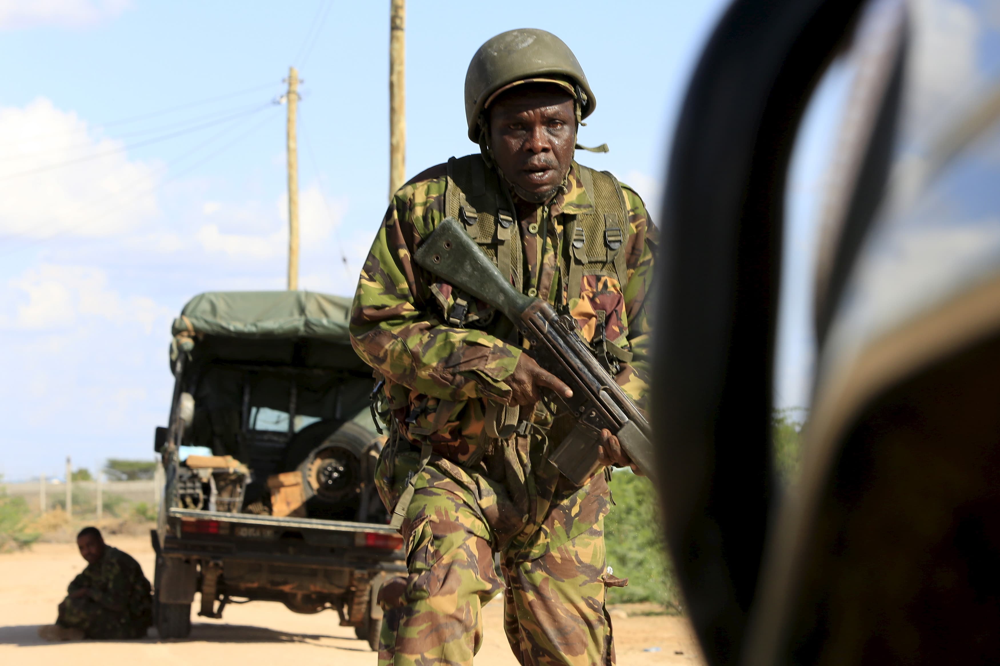 A Kenya Defense Force soldier runs for cover during al-Shabab's attack on a university compound in Garissa on April 2, 2015.