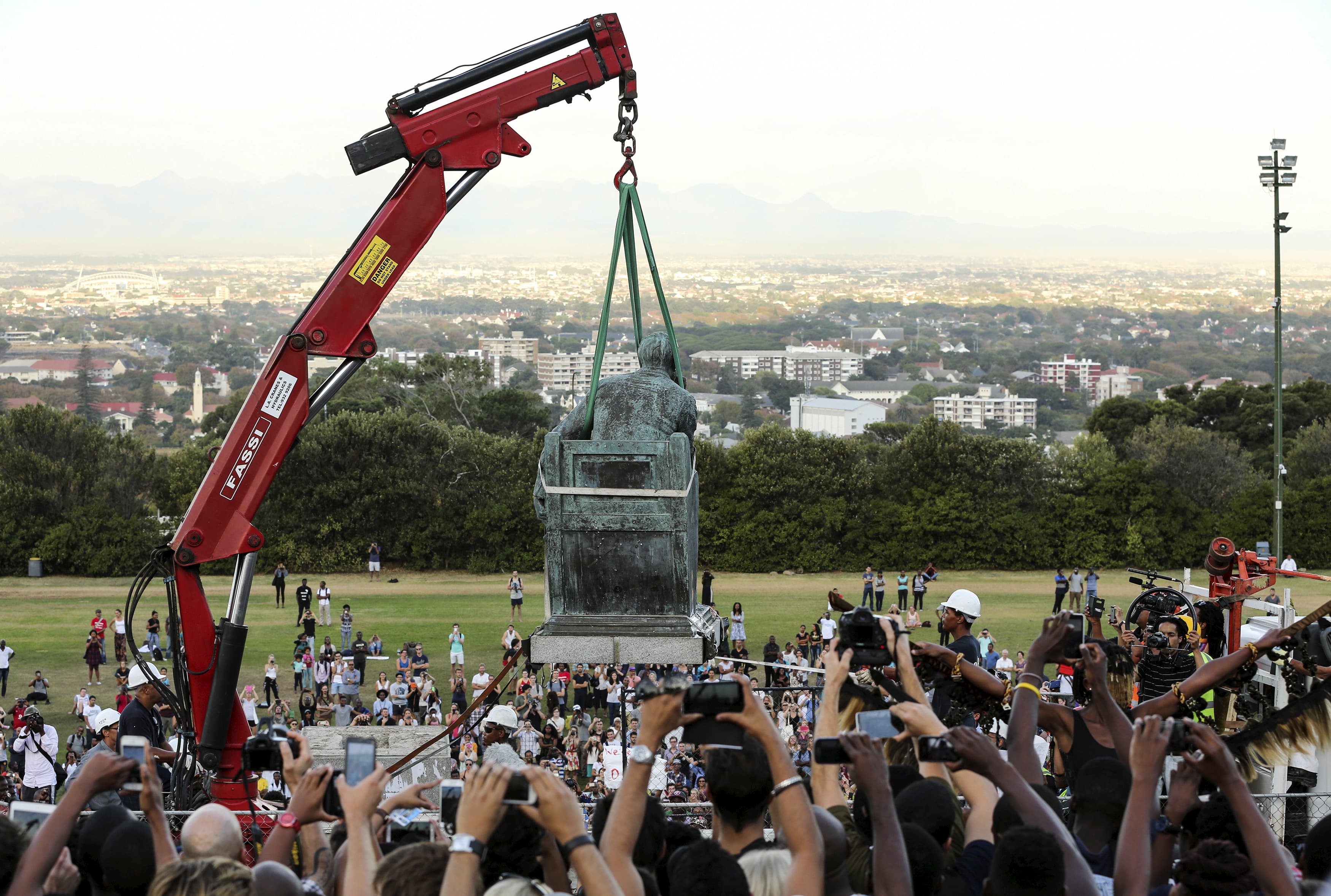 Students cheer as the statue of Cecil John Rhodes is removed from the University of Cape Town (UCT), April 9, 2015.