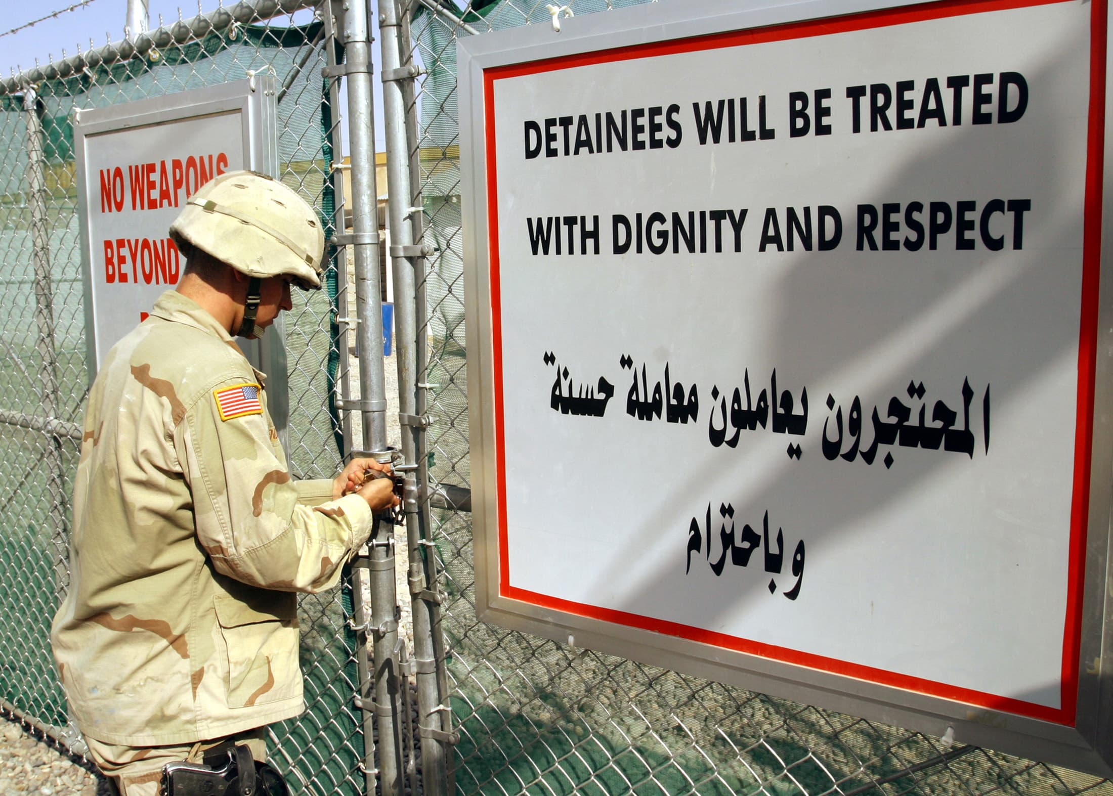 A US Army soldier from the 1st Infantry Division stationed in Tikrit closes the entrance of the dentention center at Forward Operating Base Danger on September 8, 2004.