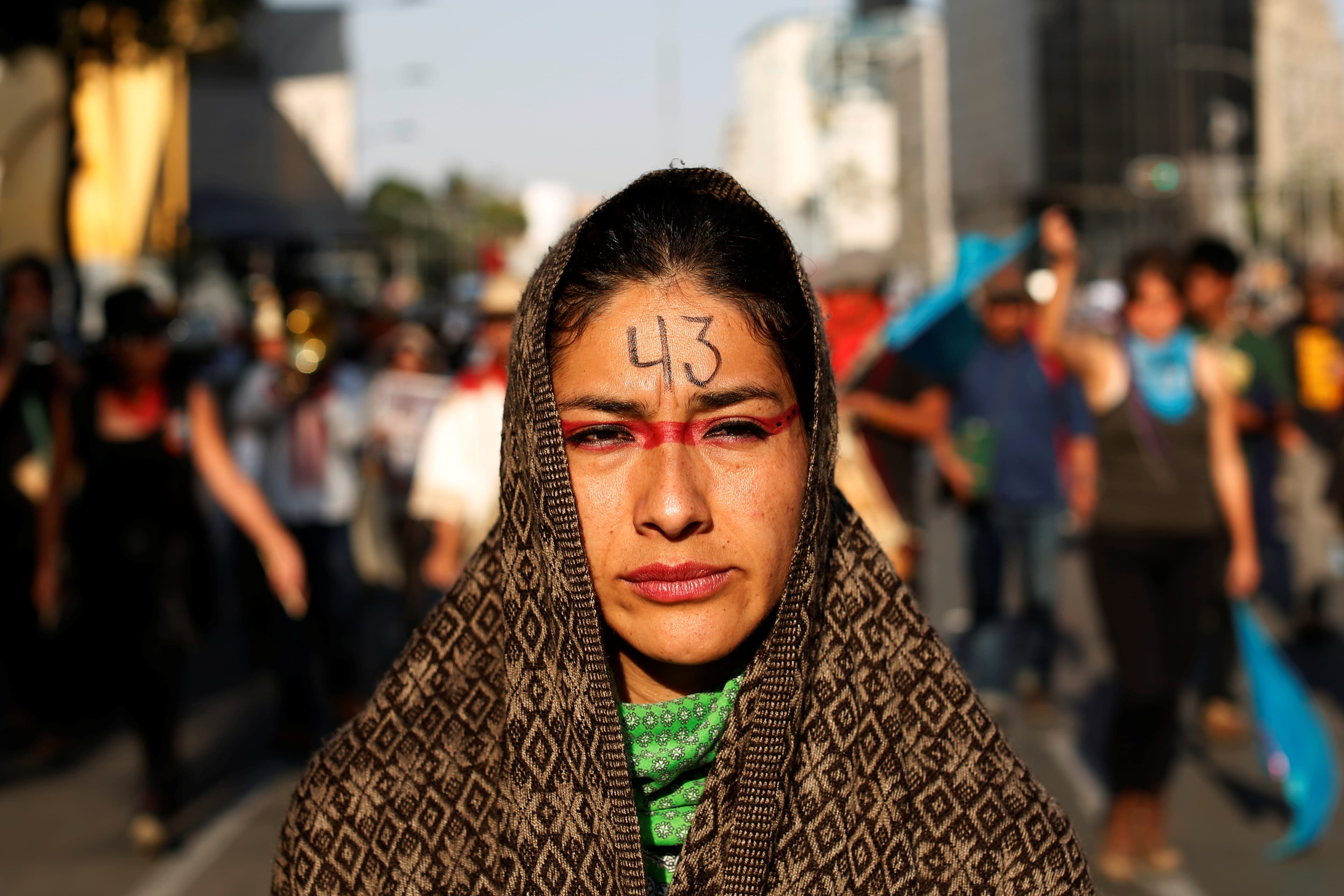 A woman takes part in a march to mark the anniversary of the disappearance of the 43 students of Ayotzinapa College Raul Isidro Burgos a in the state of Guerrero in Mexico City, Mexico February 26, 2017.