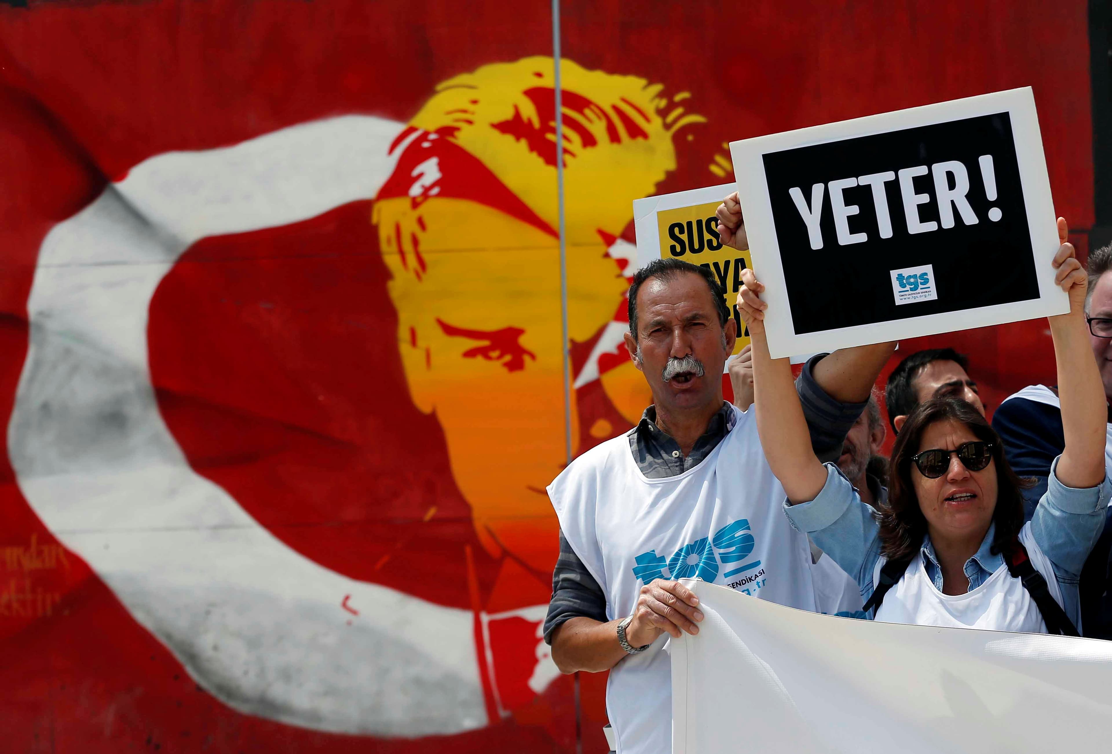 Members of the Journalists Union of Turkey (TGS) shout slogans during a demonstration to mark World Press Freedom Day in central Istanbul, Turkey, May 3, 2017. The placard reads: "Enough!"