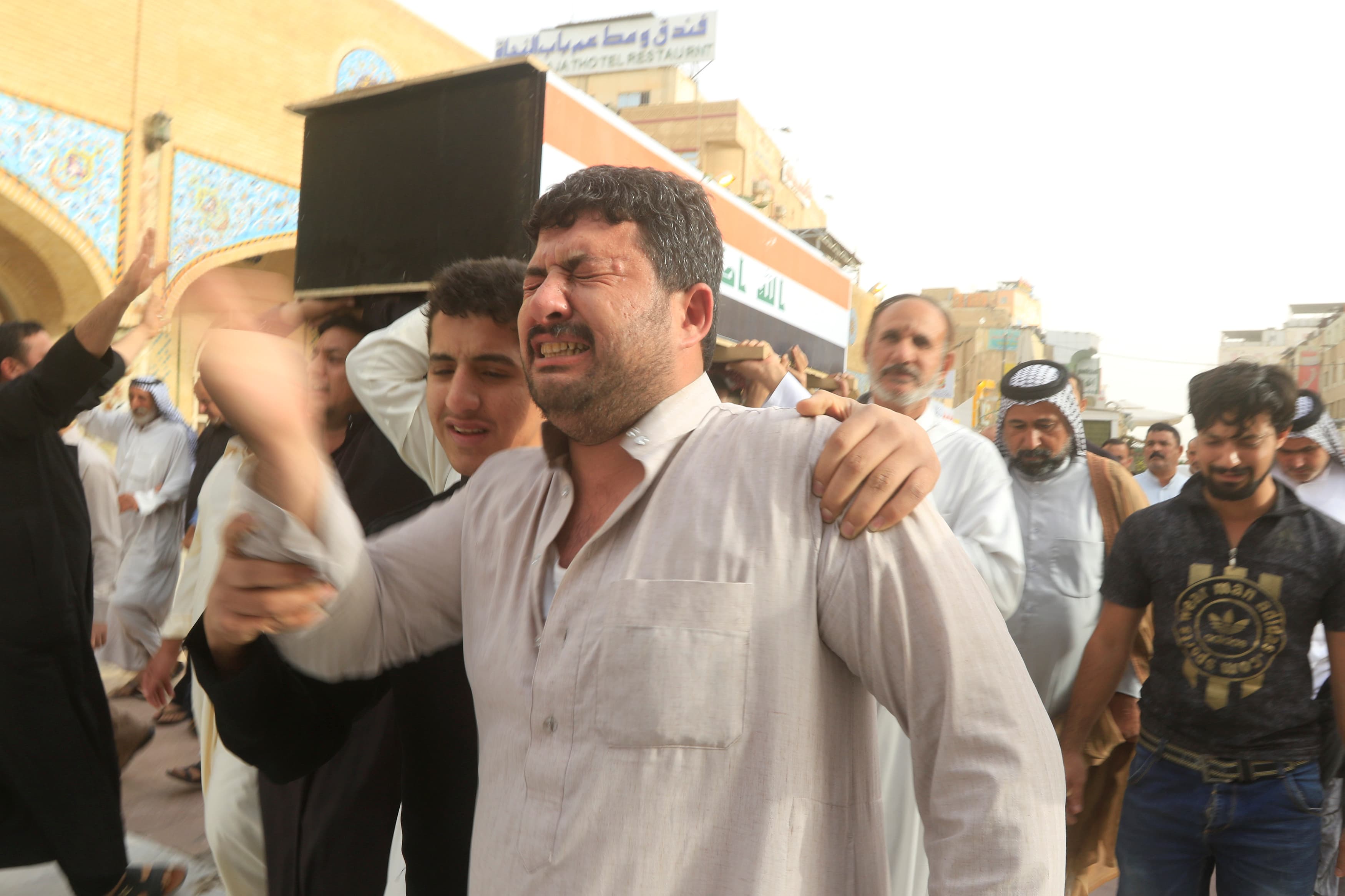 Mourners carry the coffin of a member of Iraqi security forces, killed during clashes in Mosul.