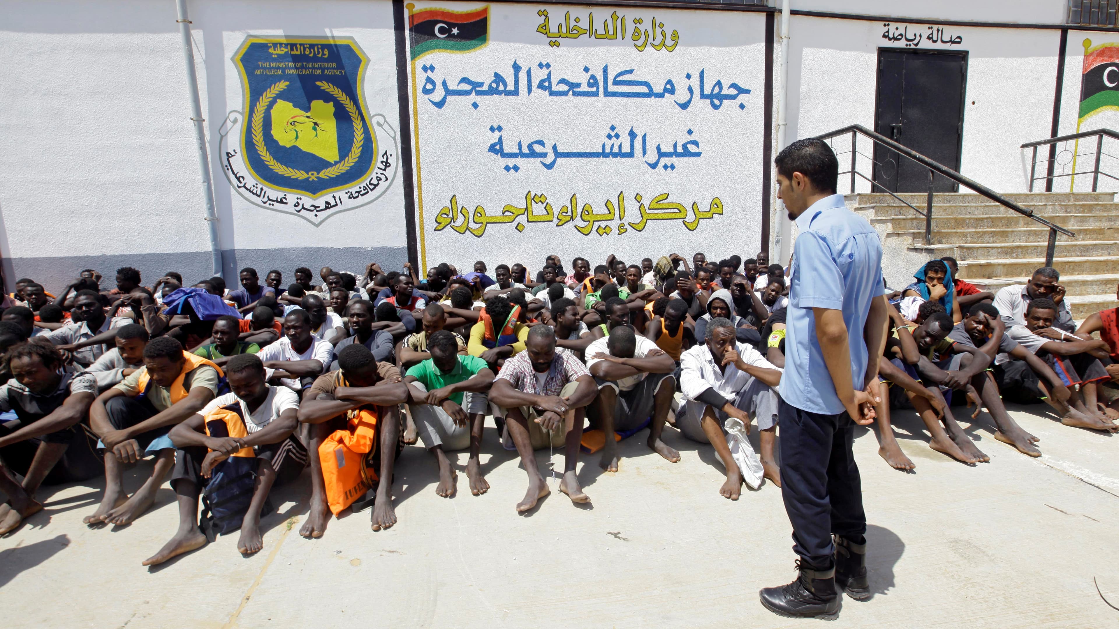 Detained migrants sit at a makeshift detention facility at Tajoura, Libya, earlier this month