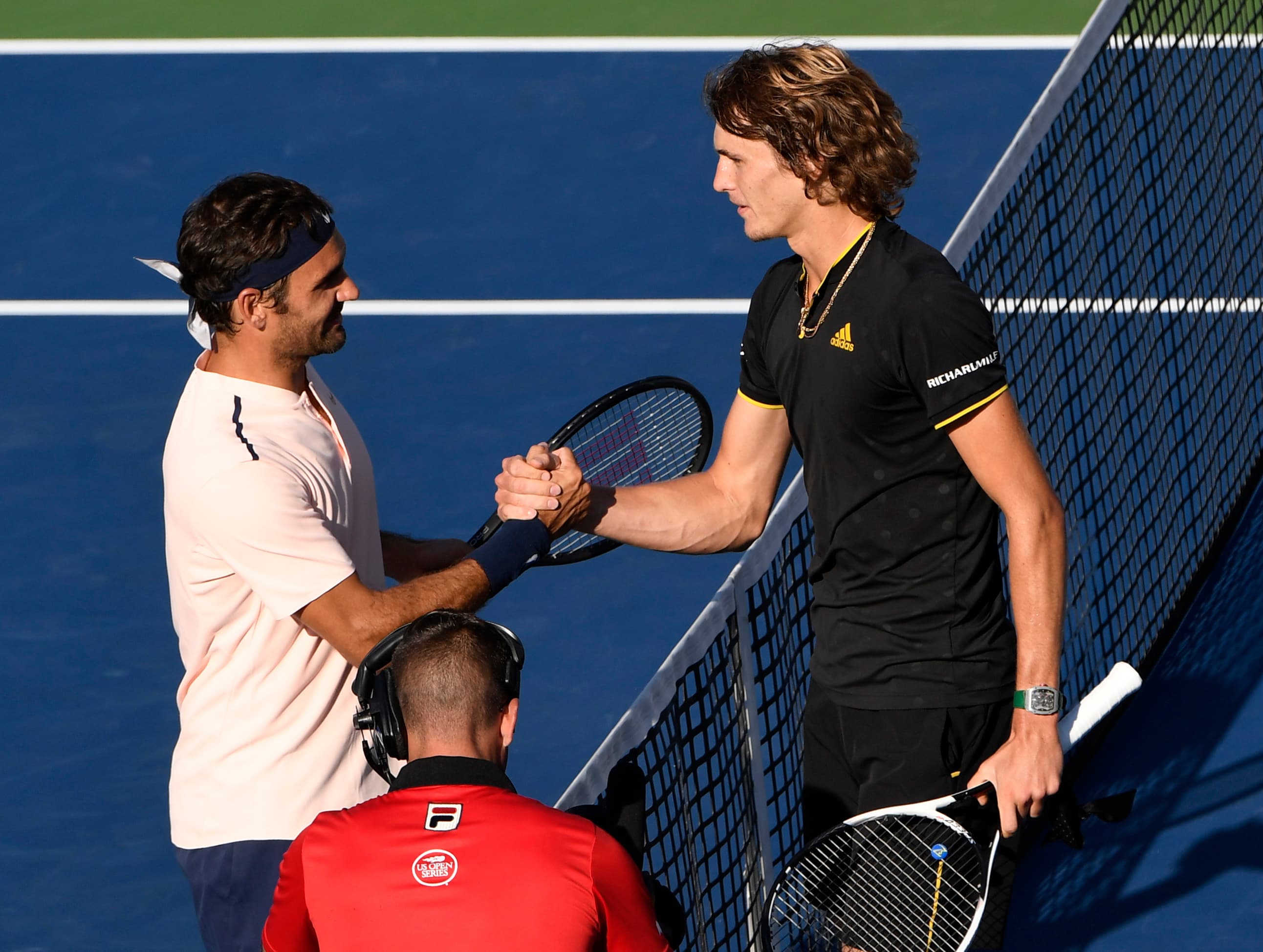 Roger Federer of Switzerland (left) shakes hands with Alexander Zverev of Germany.