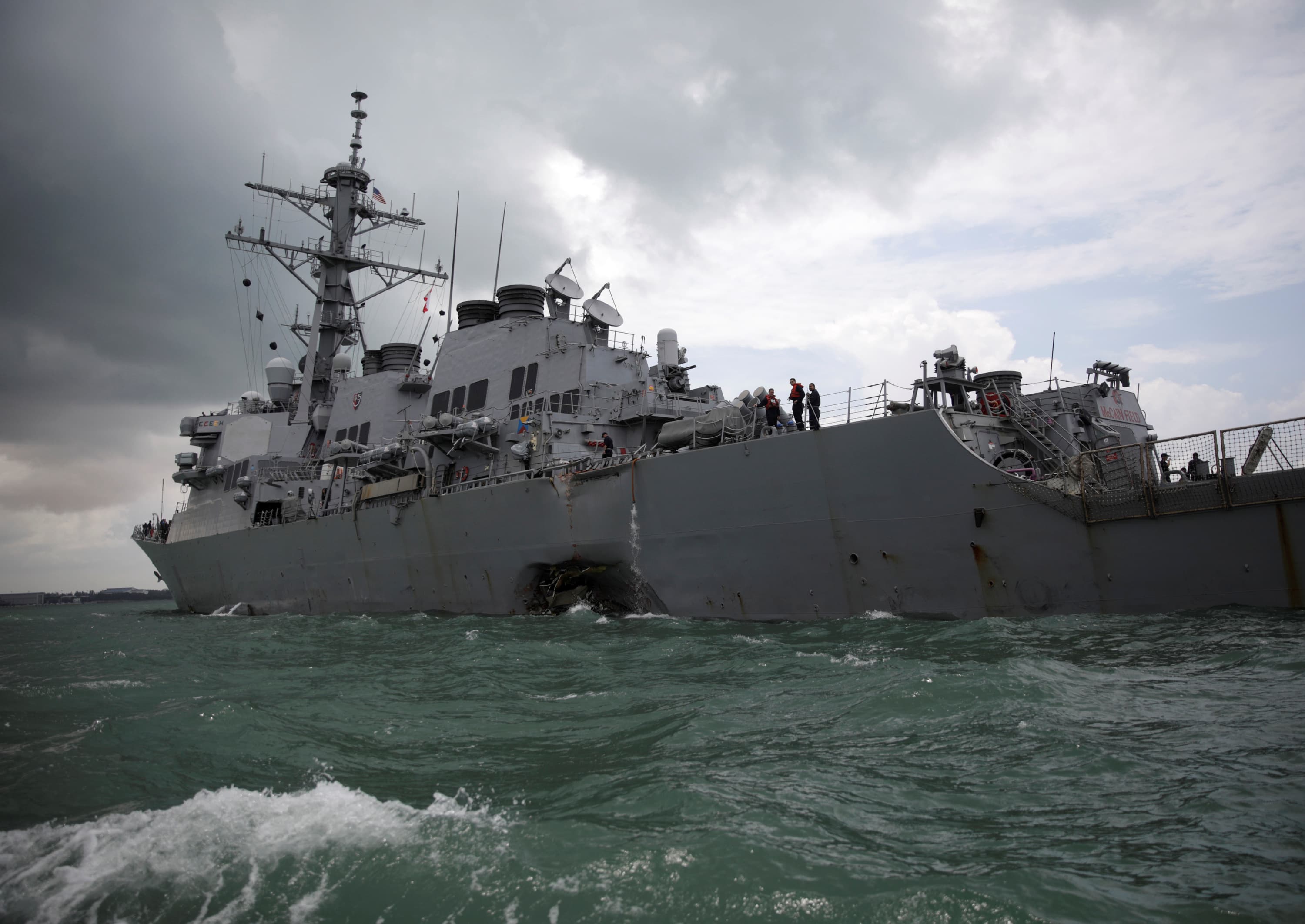 A gash can be seen in the destroyer, the USS John S. McCain, after a collision with civilian ship on Monday