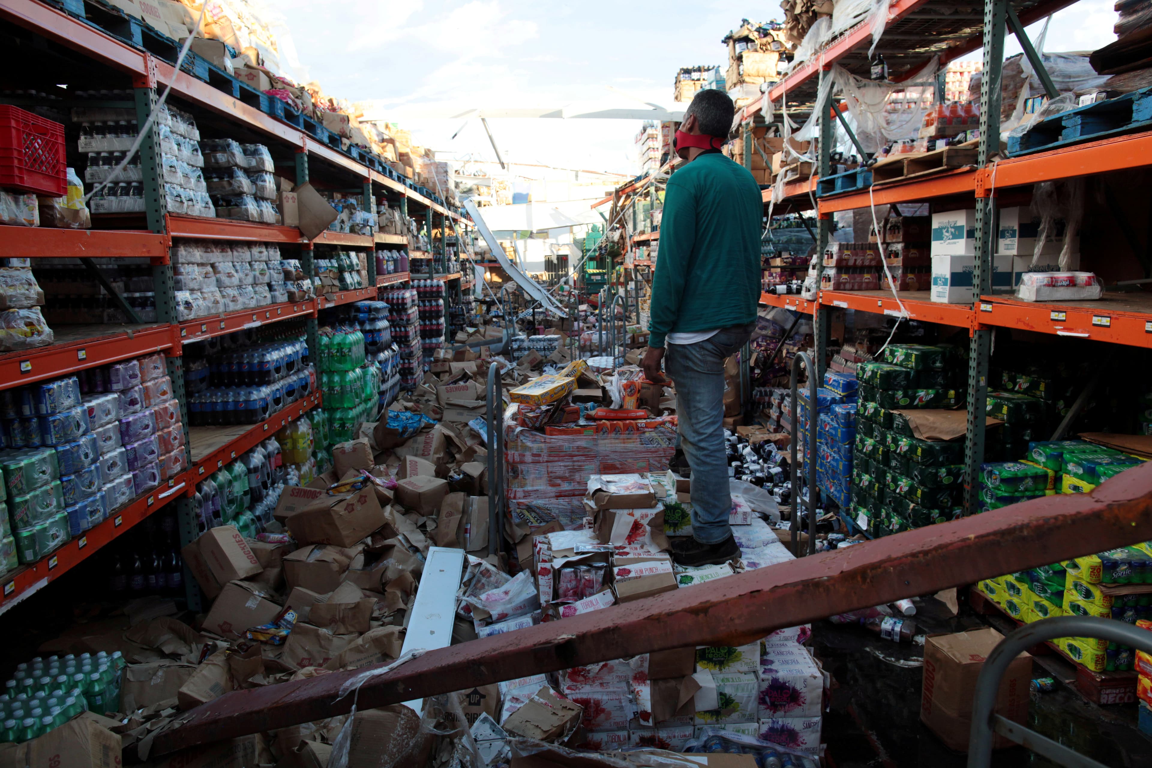 A man stands inside of a destroyed supermarket by Hurricane Maria in Salinas, Puerto Rico, Sept. 29, 2017.