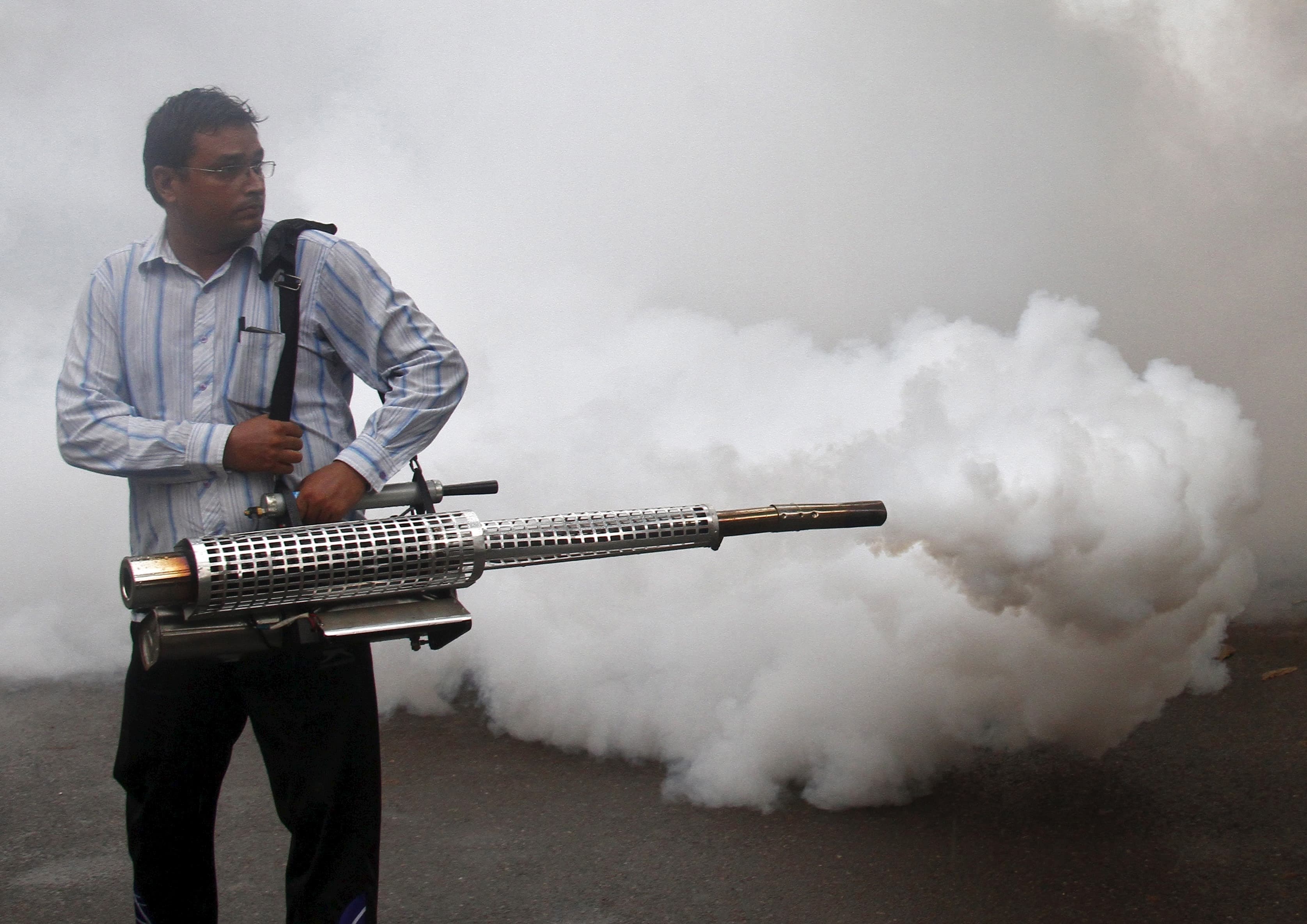 A health worker fumigates a residential area to prevent the spread of dengue fever in Chandigarh, India, September 20, 2015.
