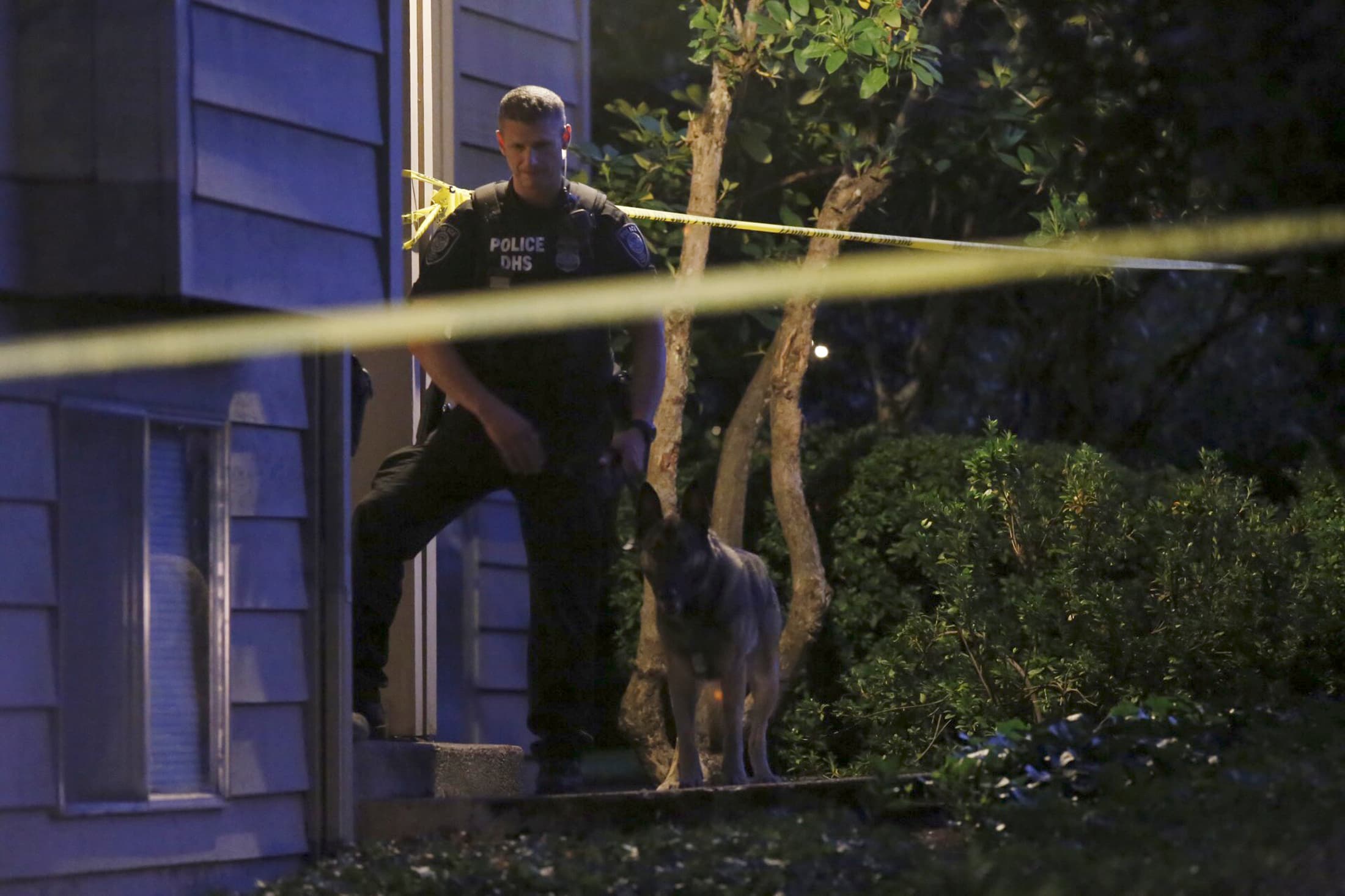 A DHS police investigator is seen with a canine at residential location following a mass shooting at Umpqua Community College in Roseburg, Oregon October 1, 2015.