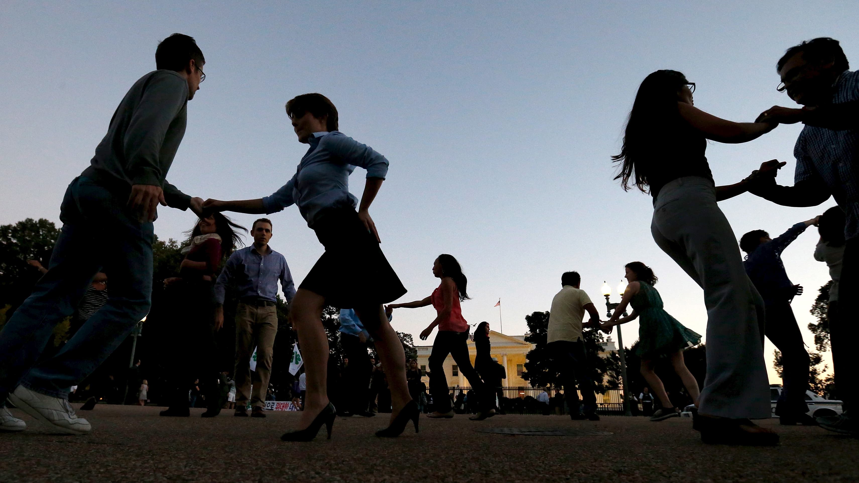 Members of social dance club, Rueda de la Calle DC, perform Cuban salsa dances on Pennsylvania Avenue in front of the White House in Washington. The group chose the White House as their venue that day because famed Cuban musical group Orquesta Buena Vista