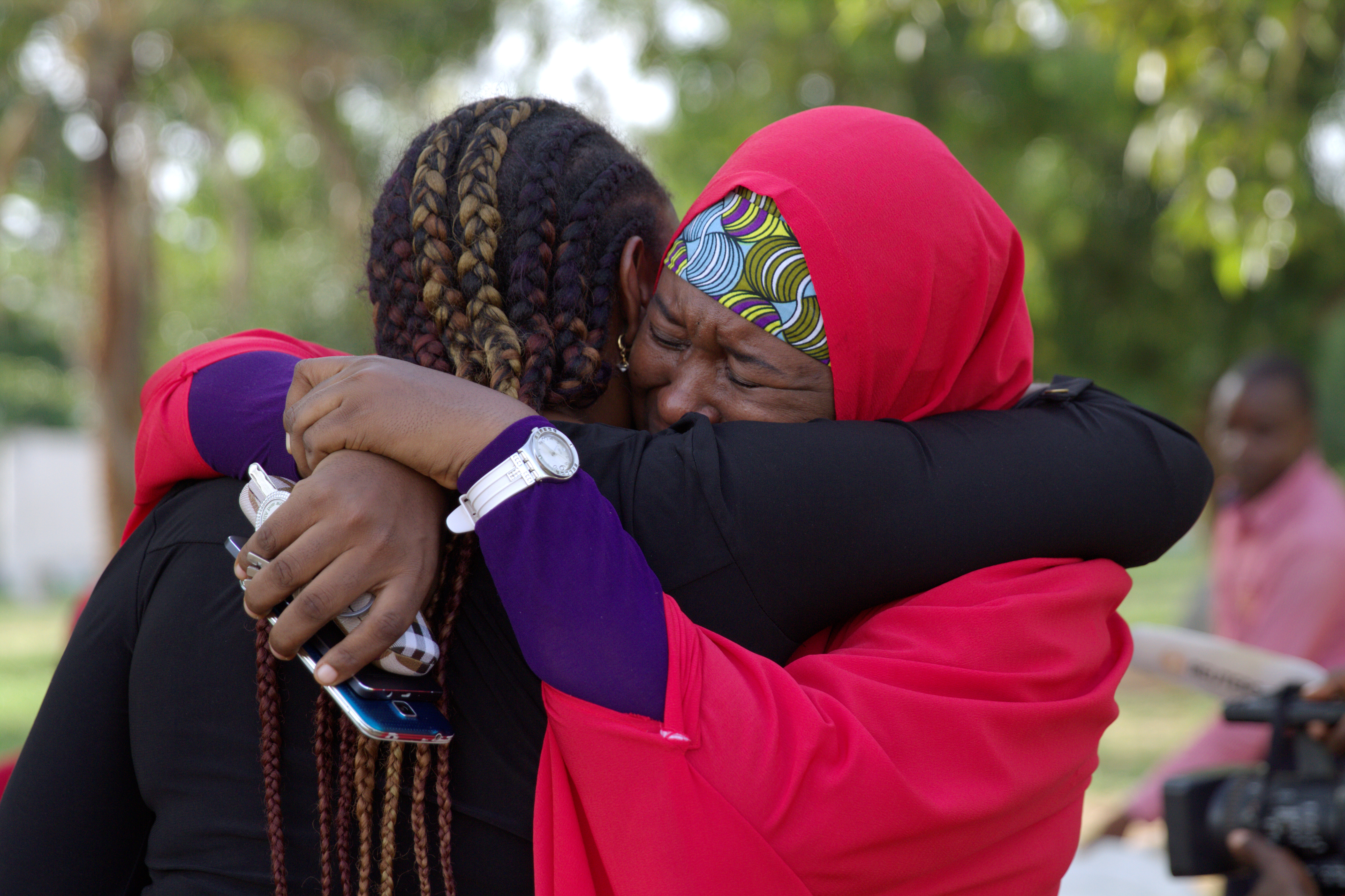 Members of the #BringBackOurGirls (#BBOG) campaign embrace each other at a sit-out in Abuja, Nigeria May 18, 2016.