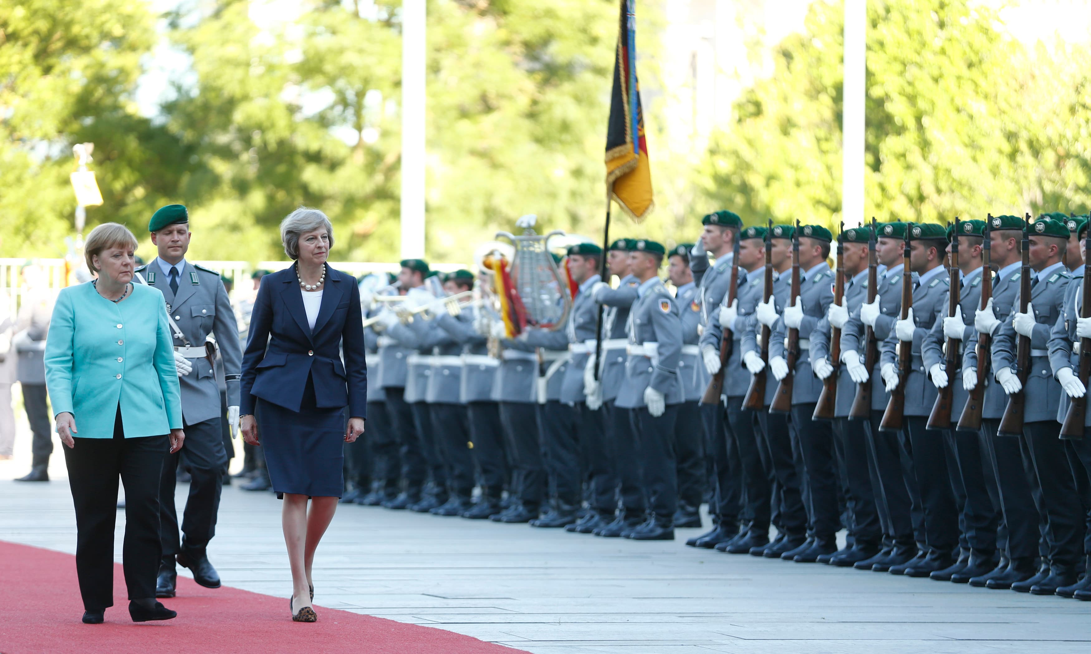German Chancellor Angela Merkel and Britain's Prime Minister Theresa May (R) review the honour guard during a welcoming ceremony at the Chancellery in Berlin, Germany July 20, 2016.