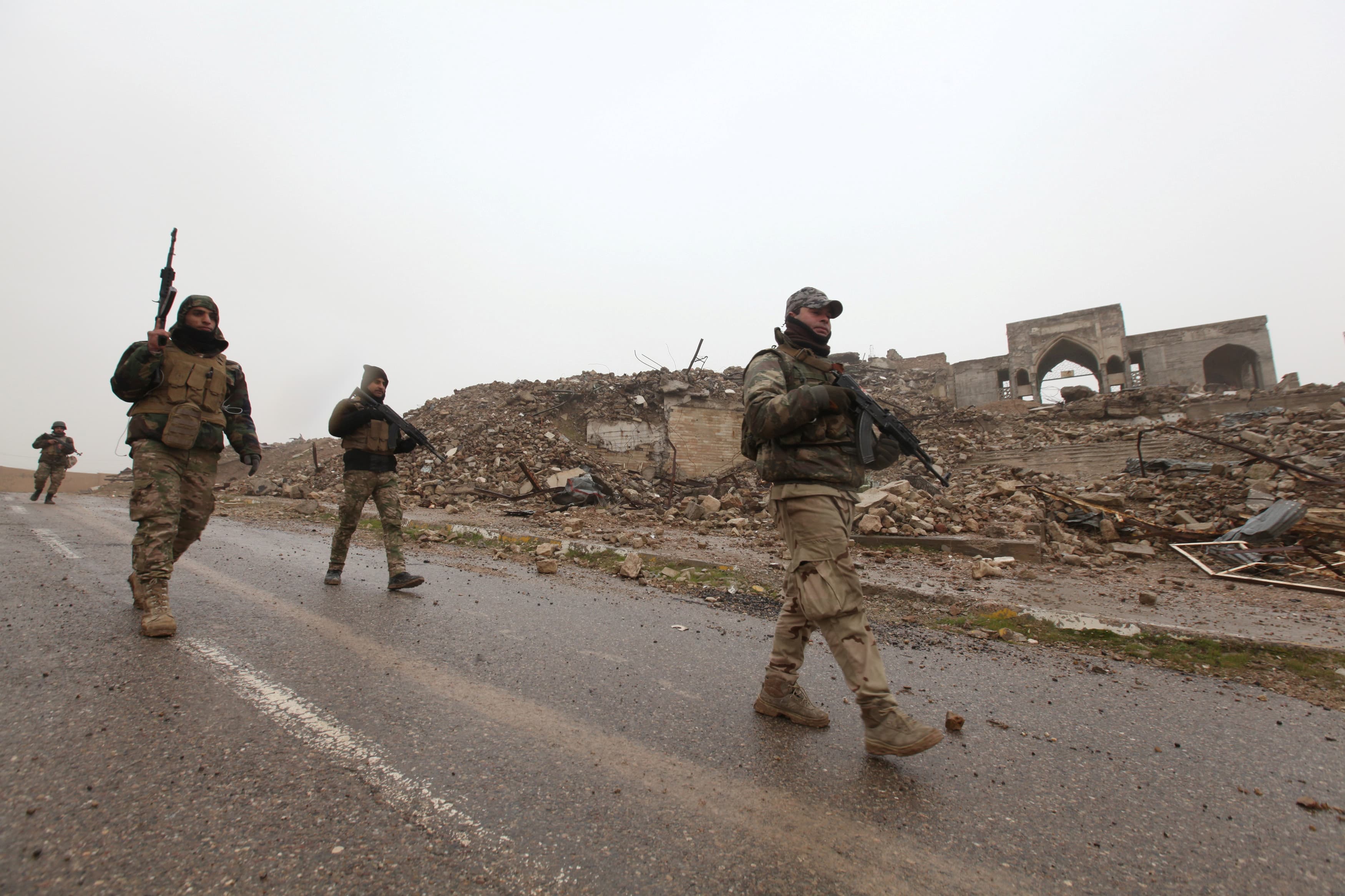 Iraqi soldiers inspect the remains of the Tomb of Prophet Yunus, destroyed by Islamic State militants, in Mosul, Iraq, January 28, 2017.