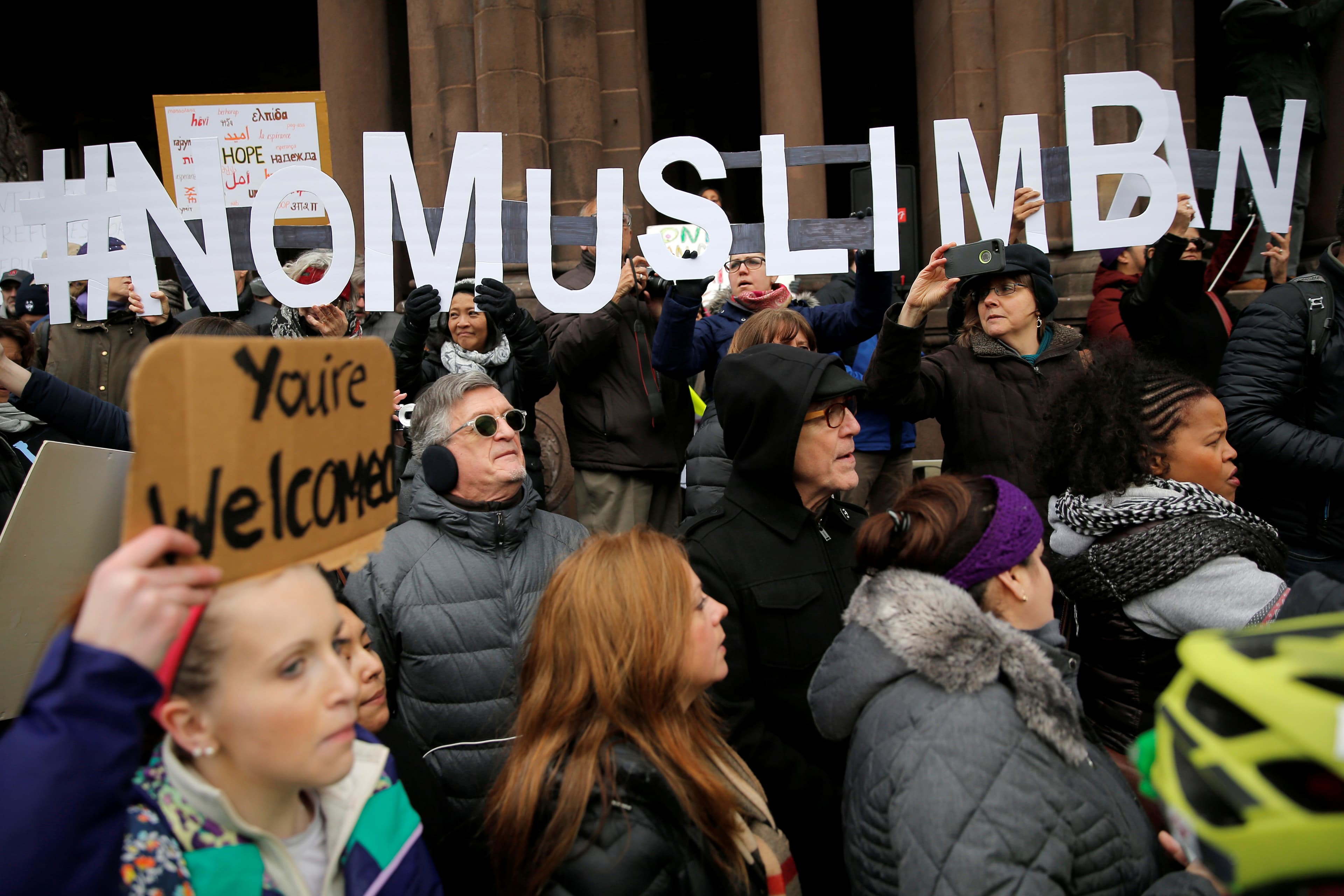 Demonstrators spell out "# No Muslim Ban" during a protest against President Donald Trump's executive order travel ban.