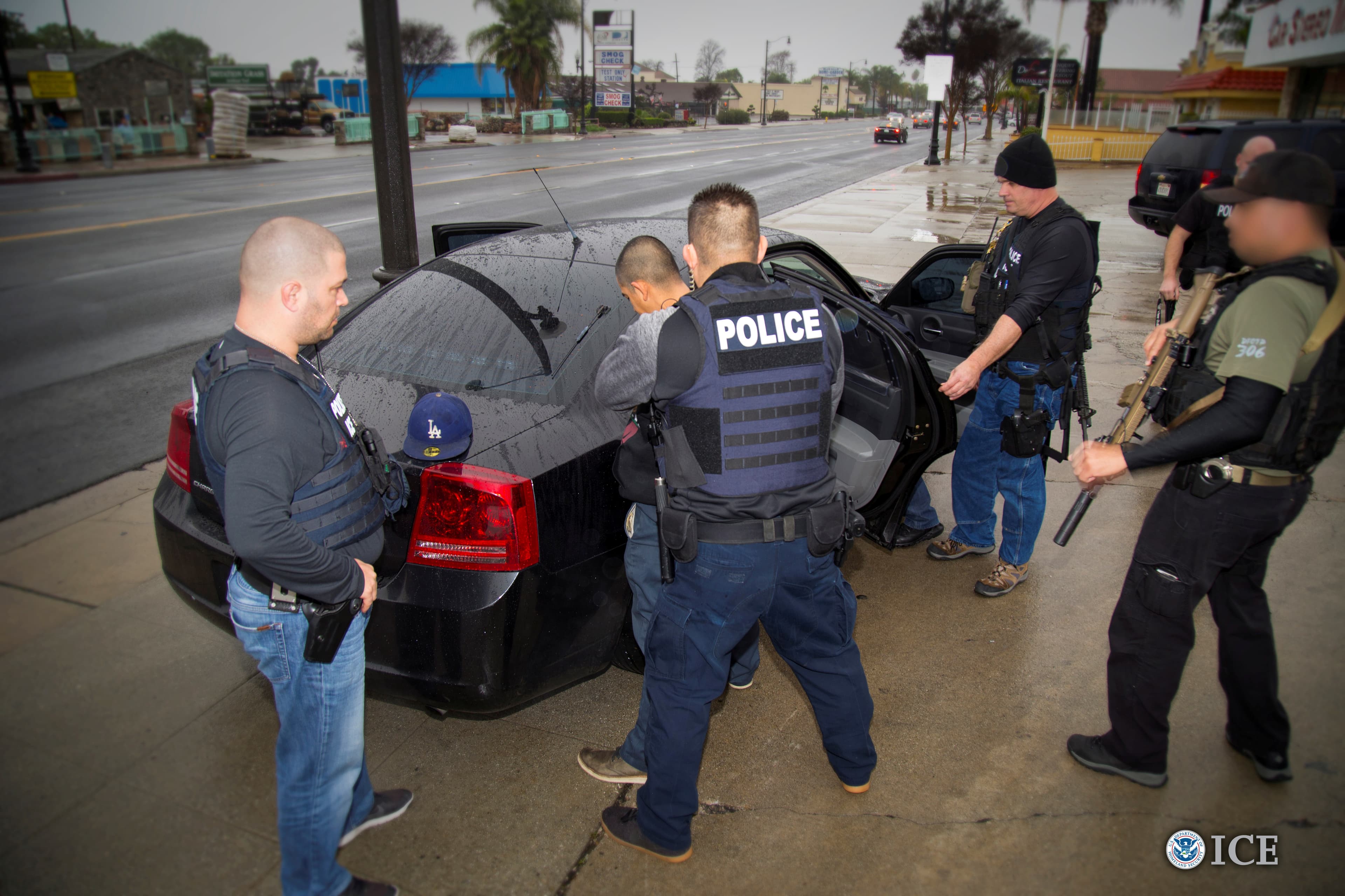 ICE officers detain a suspect as they conduct a targeted enforcement operation in Los Angeles.